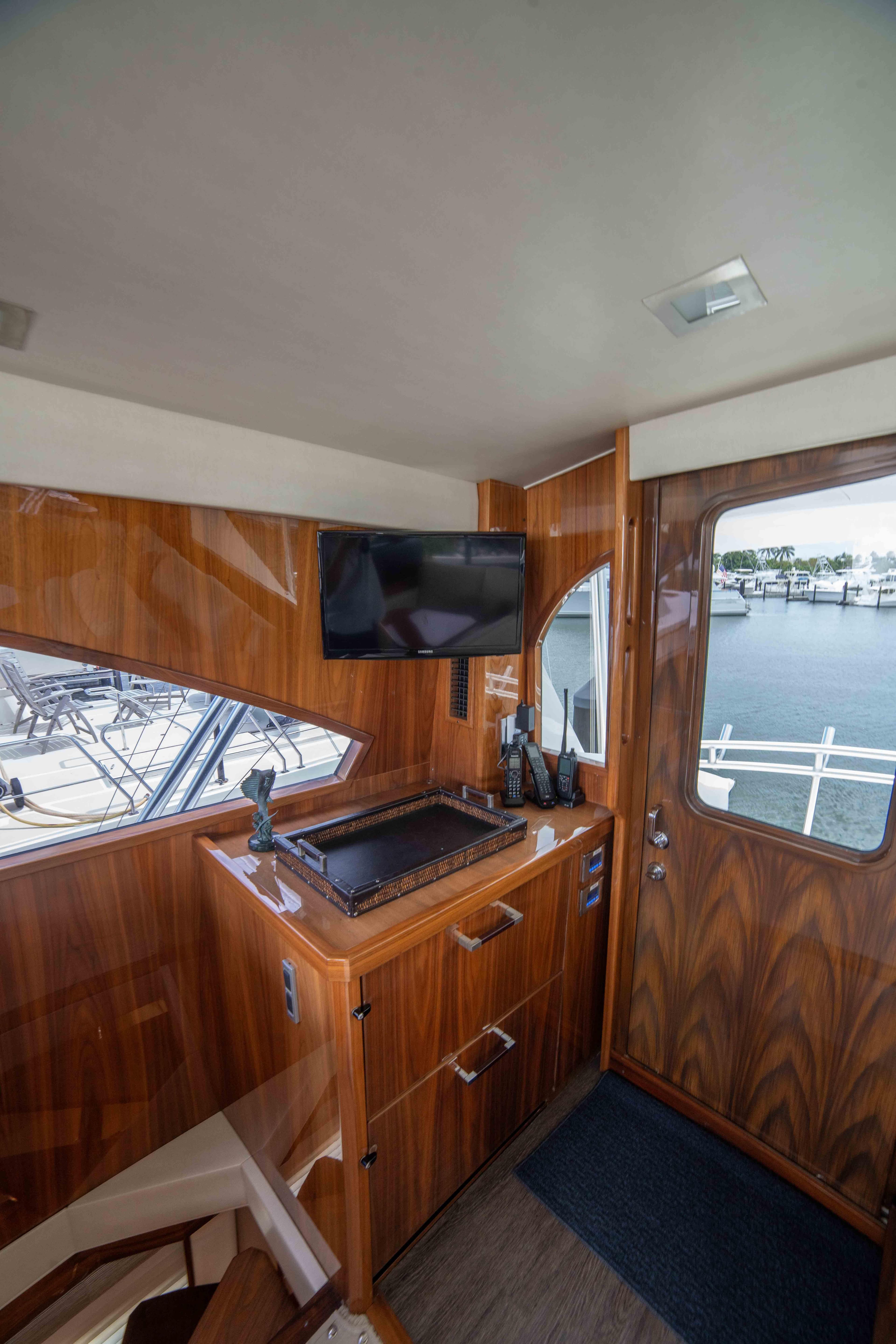 Interior of 2019 Viking 72 Enclosed Bridge yacht with wood paneling and modern amenities.
