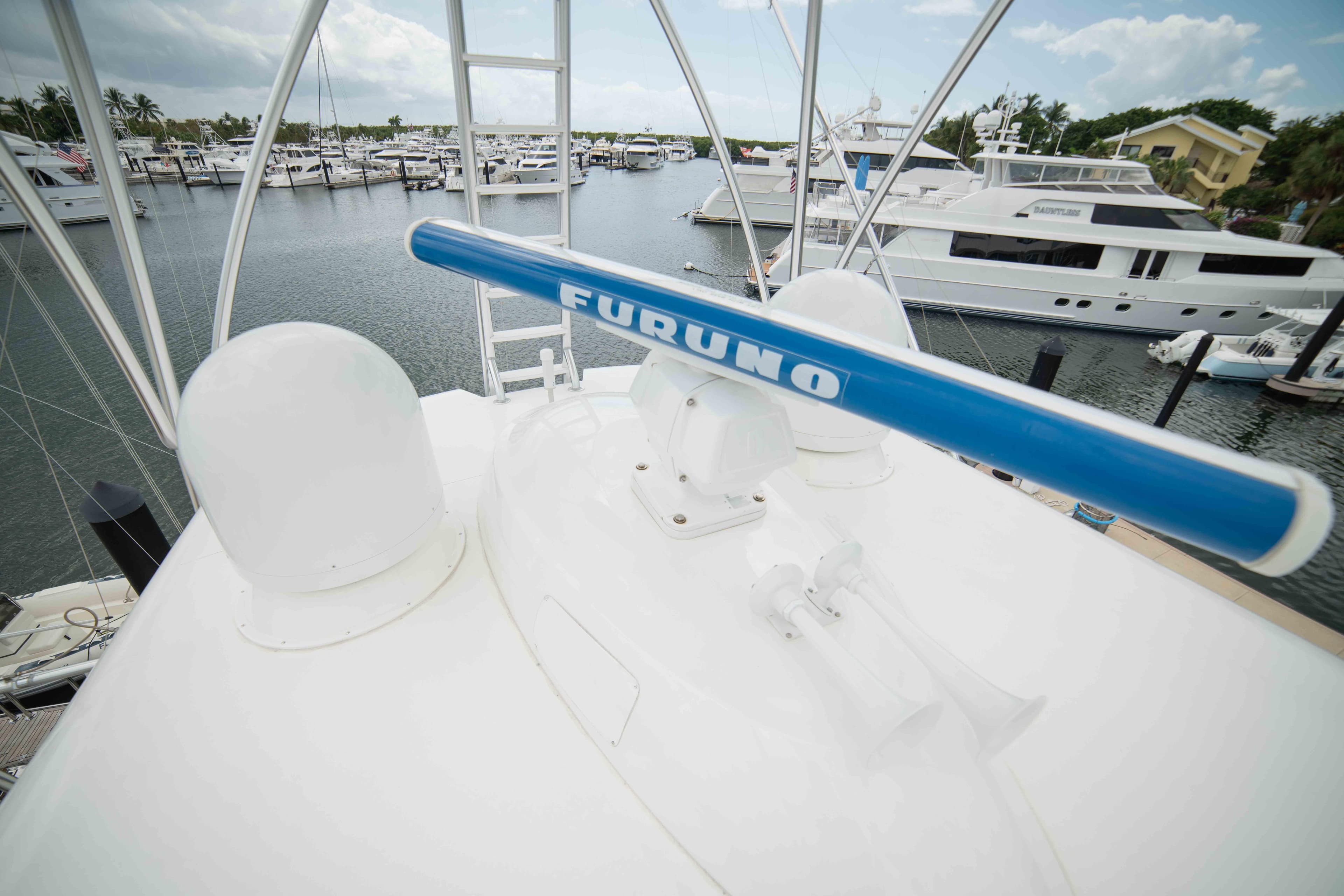 Radar equipment on 2019 Viking 72 Enclosed Bridge yacht, docked in a marina.
