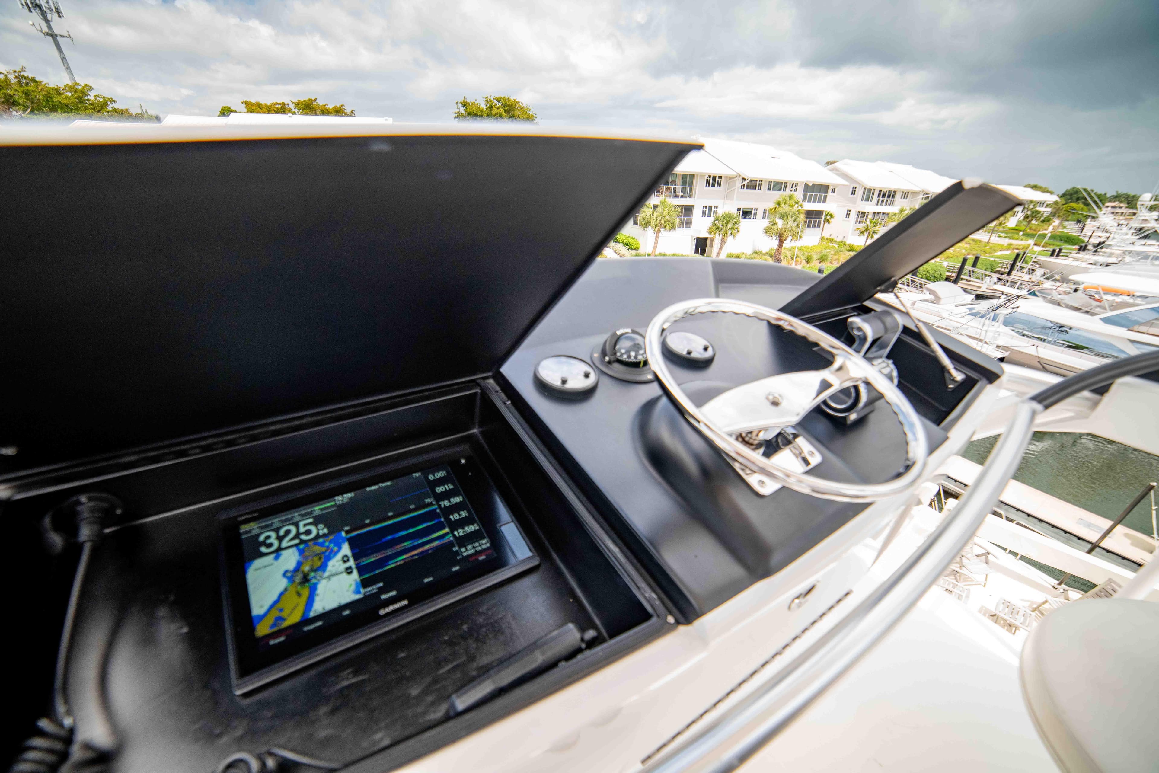 2019 Viking 72 Enclosed Bridge yacht helm with navigation display and steering wheel.