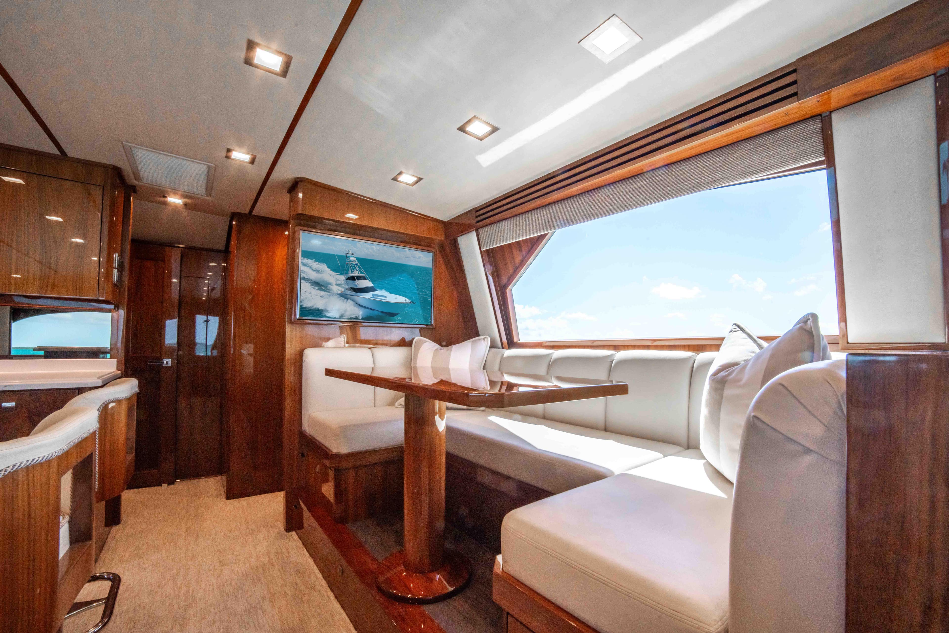 Luxurious interior of 2019 Viking 72 Enclosed Bridge yacht with elegant seating and large windows.