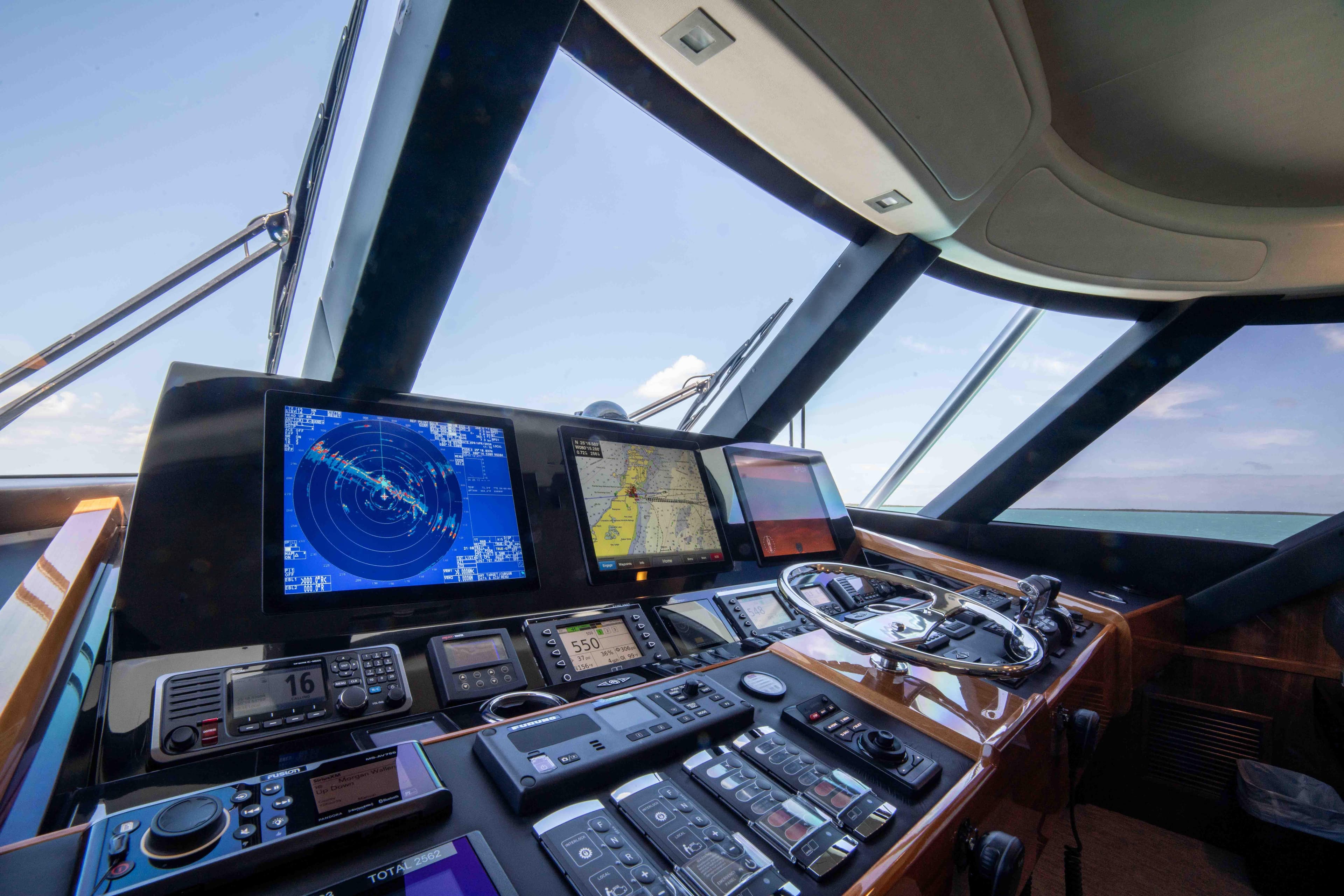 Control panel of 2019 Viking 72 Enclosed Bridge yacht with navigation screens.