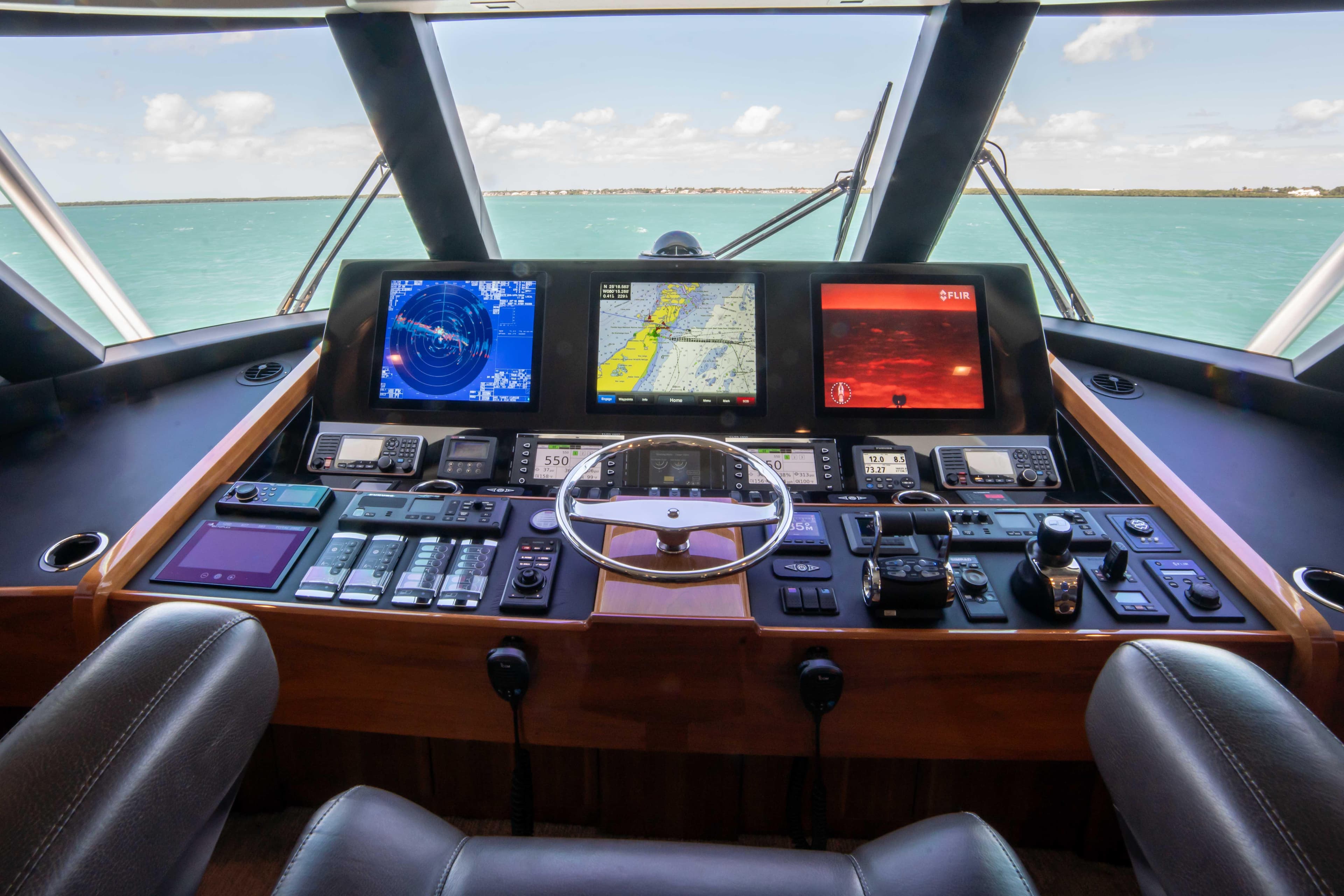 Control panel of 2019 Viking 72 Enclosed Bridge yacht with navigation screens.