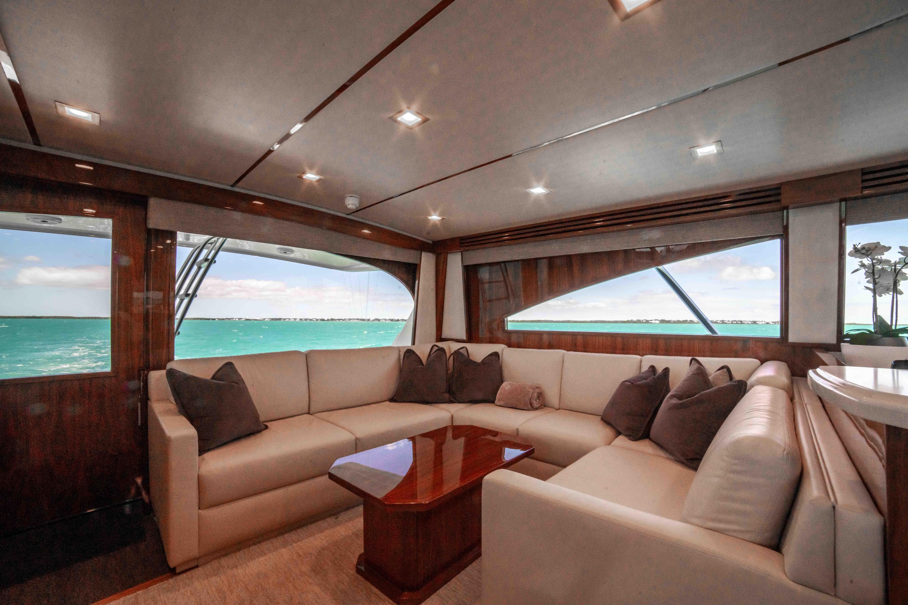 Luxurious interior of 2019 Viking 72 Enclosed Bridge yacht with ocean view.