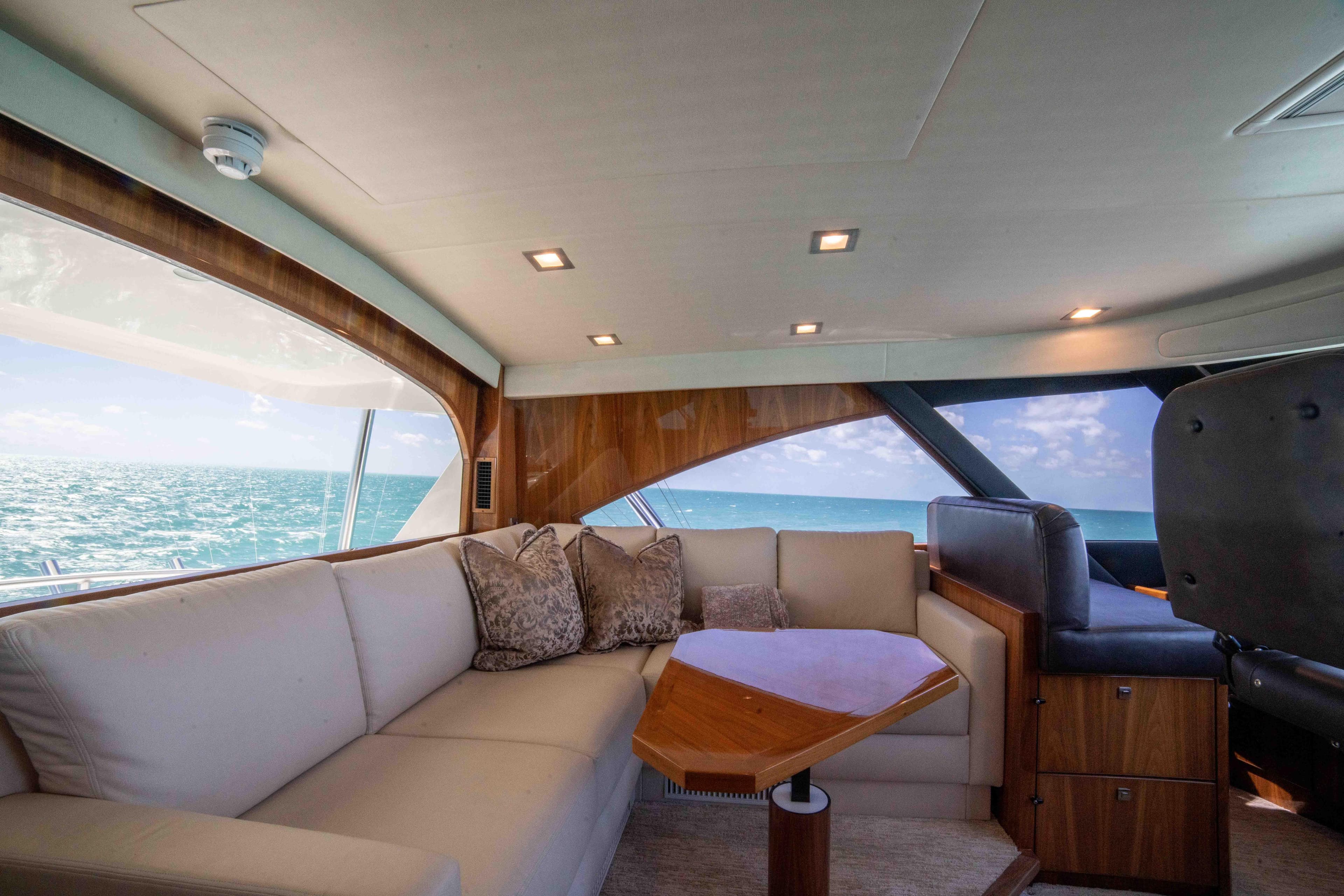 Luxurious interior of 2019 Viking 72 Enclosed Bridge yacht with ocean view.