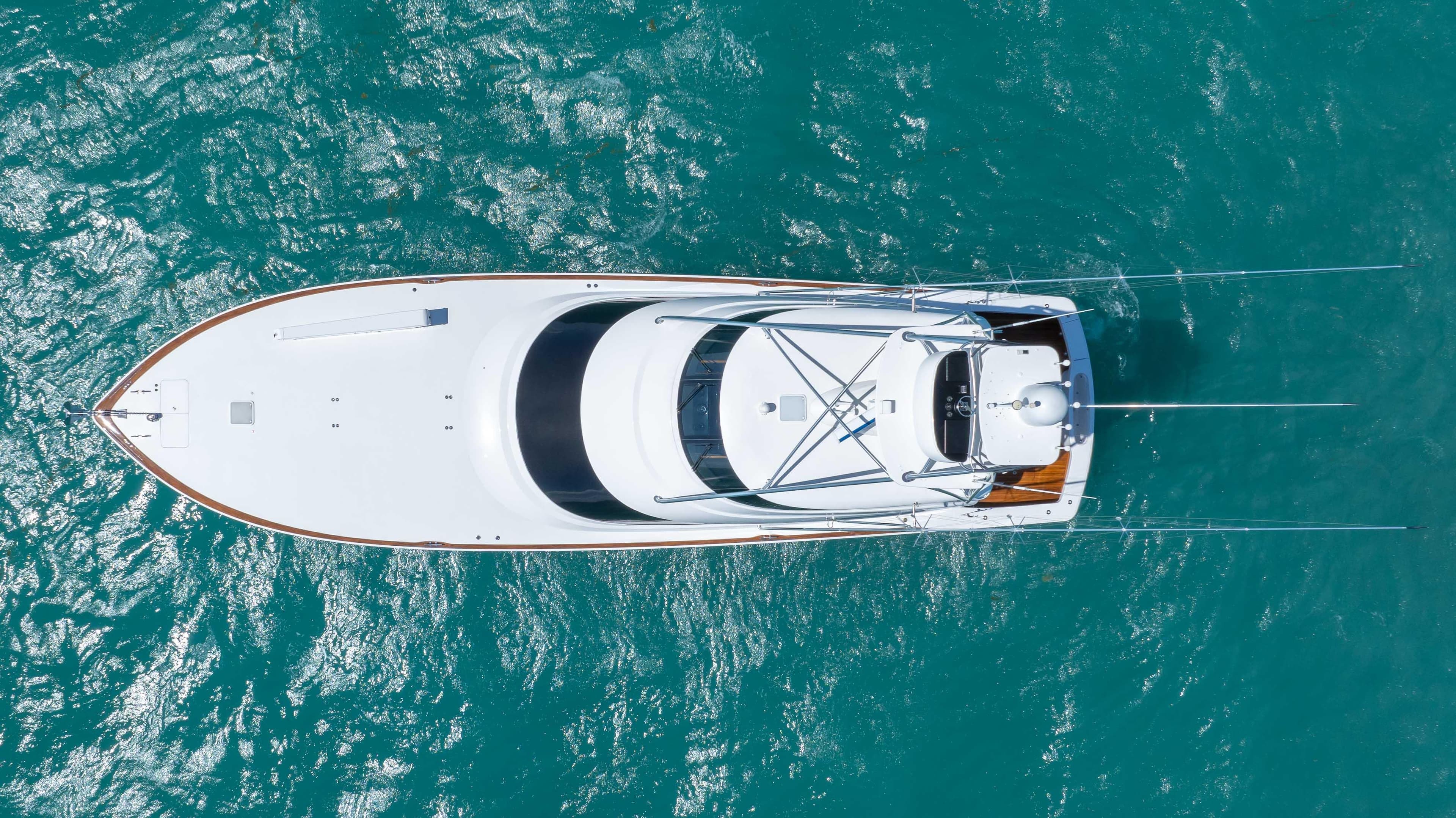 Aerial view of 2019 Viking 72 Enclosed Bridge yacht on turquoise water.