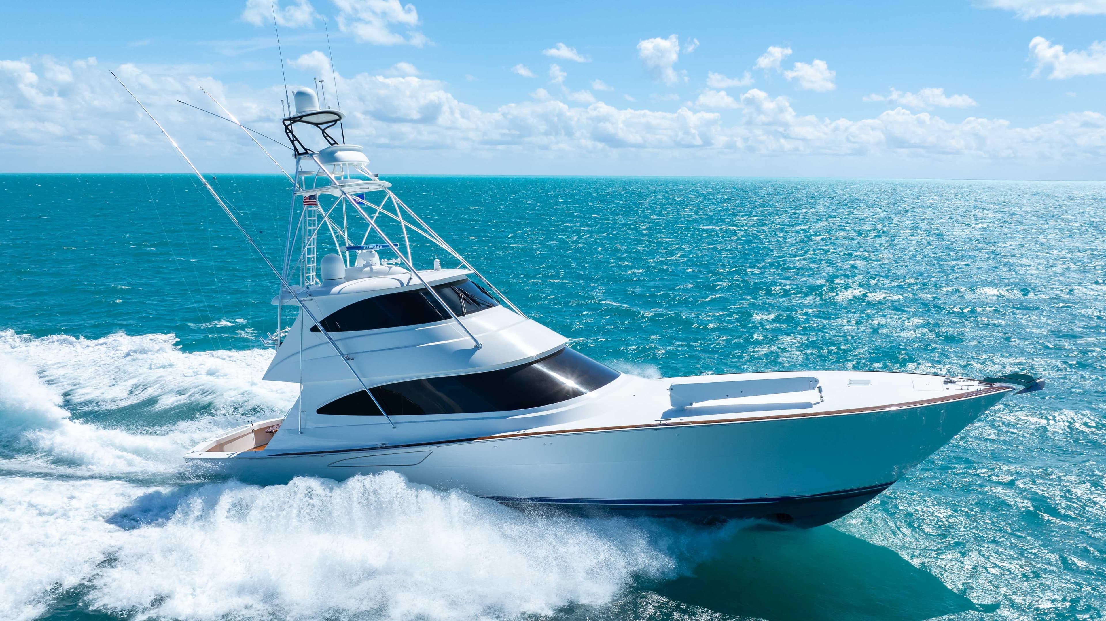 2019 Viking 72 Enclosed Bridge yacht cruising on open ocean under clear skies.