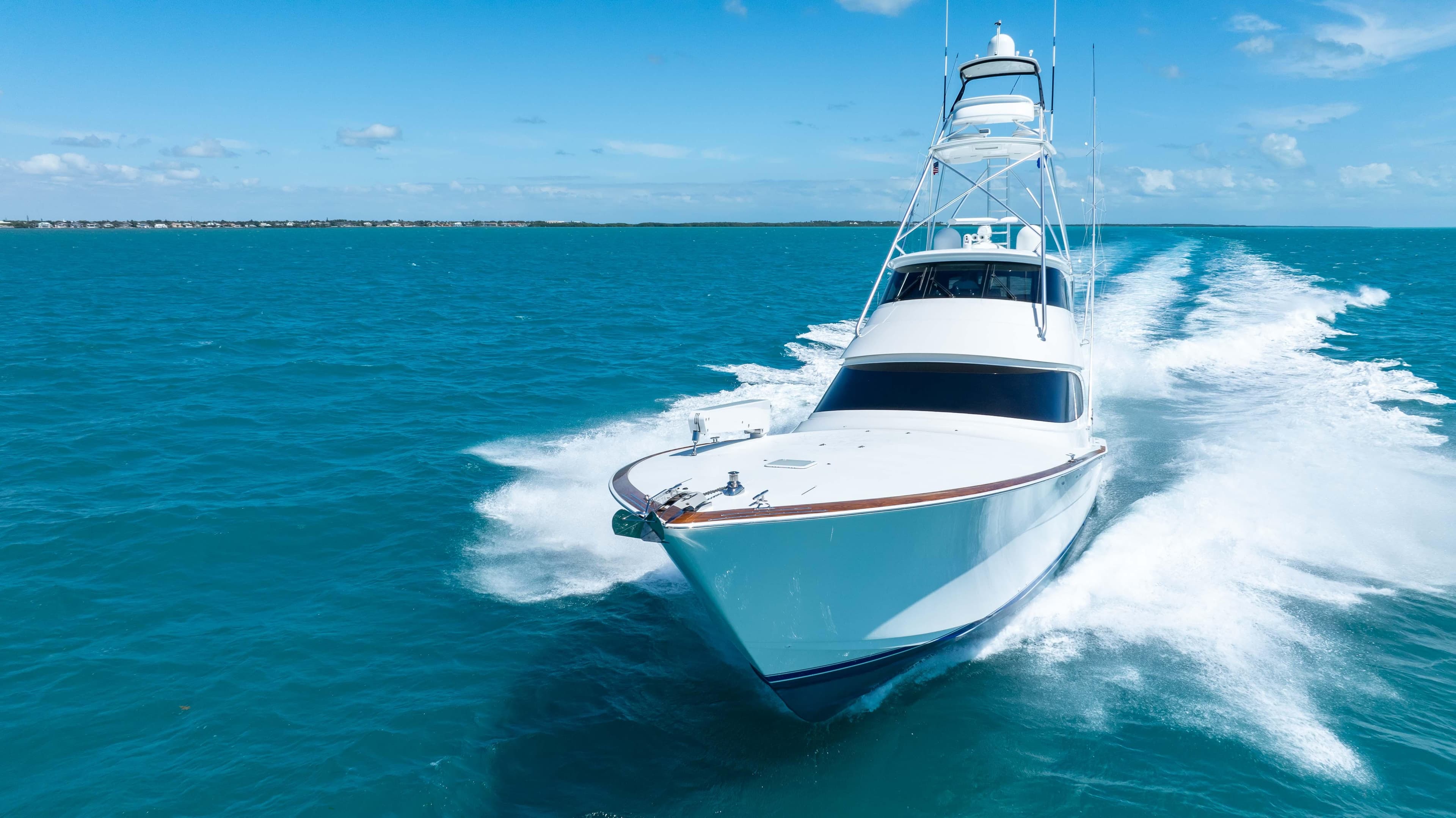 2019 Viking 72 Enclosed Bridge yacht cruising on open blue waters.