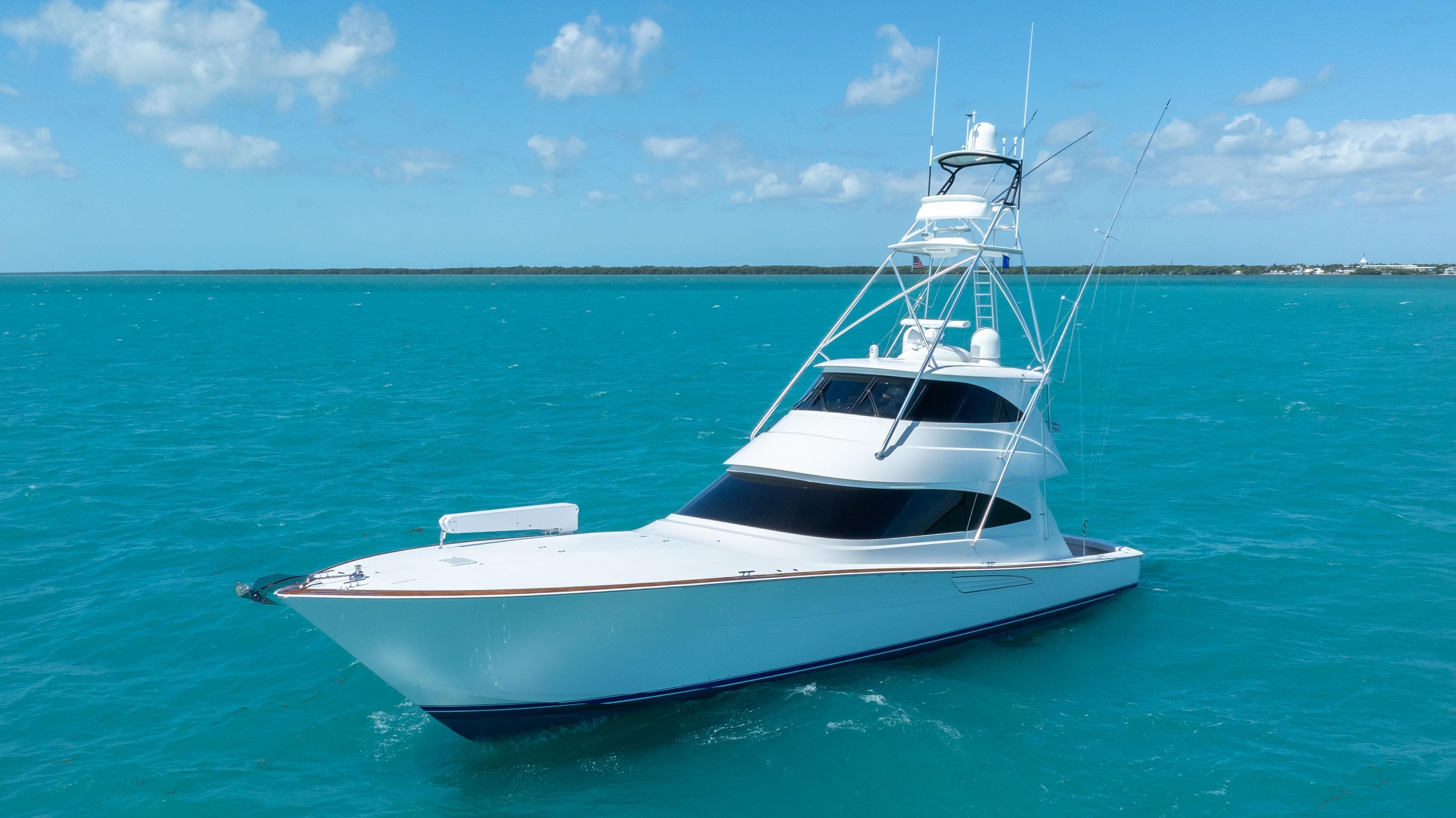 2019 Viking 72 Enclosed Bridge yacht on turquoise ocean waters.