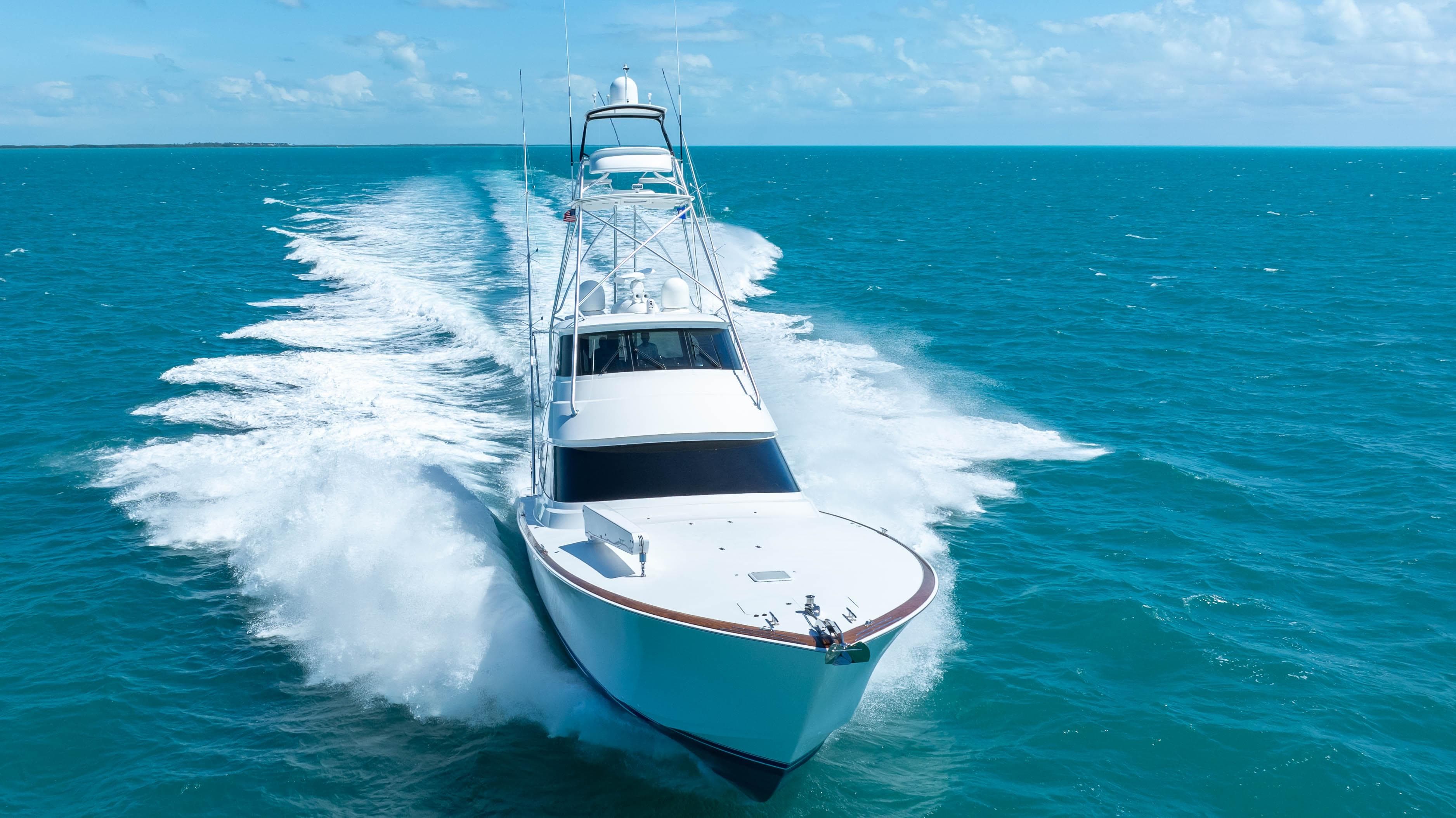 2019 Viking 72 Enclosed Bridge yacht cruising on open blue sea.