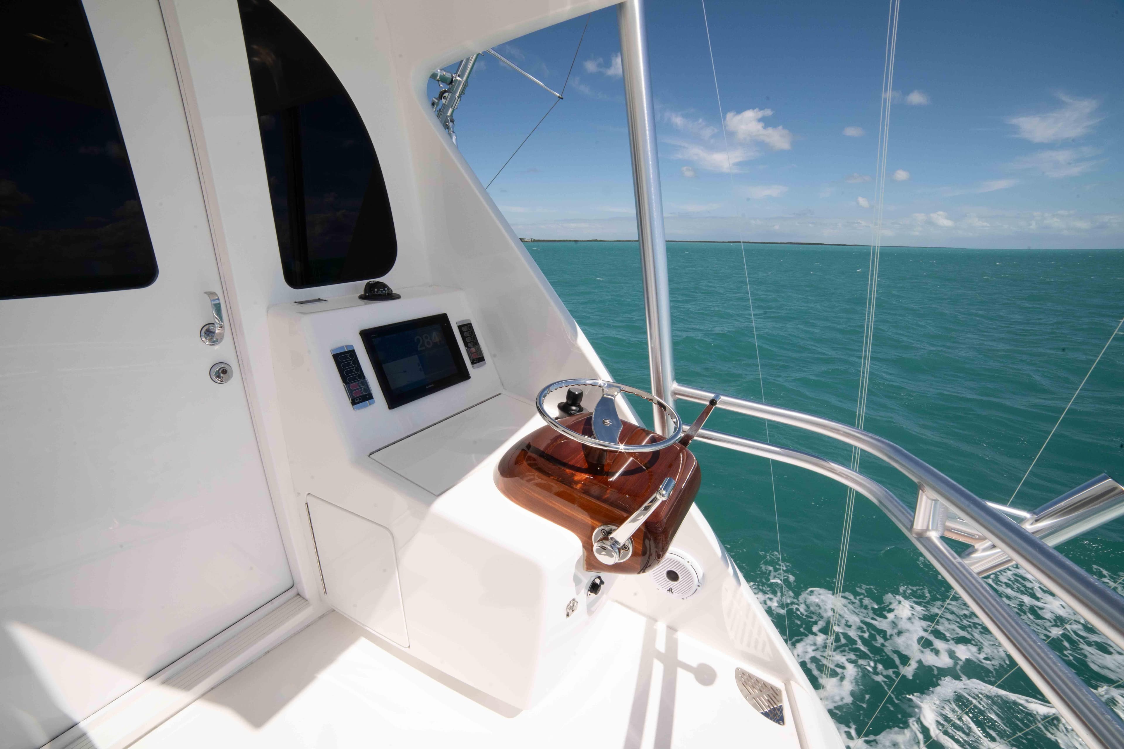 2019 Viking 72 Enclosed Bridge yacht helm with ocean view.