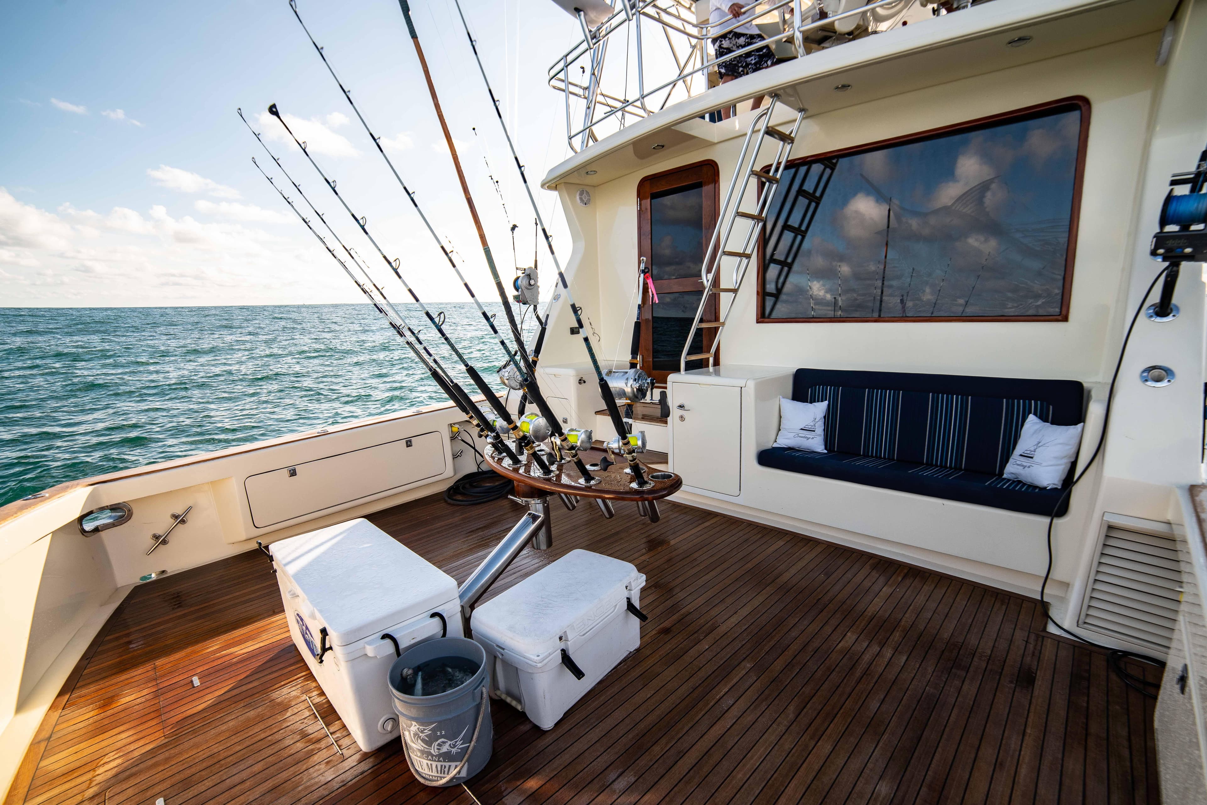 1996 Donzi 72 Custom Convertible fishing deck with rods and seating.