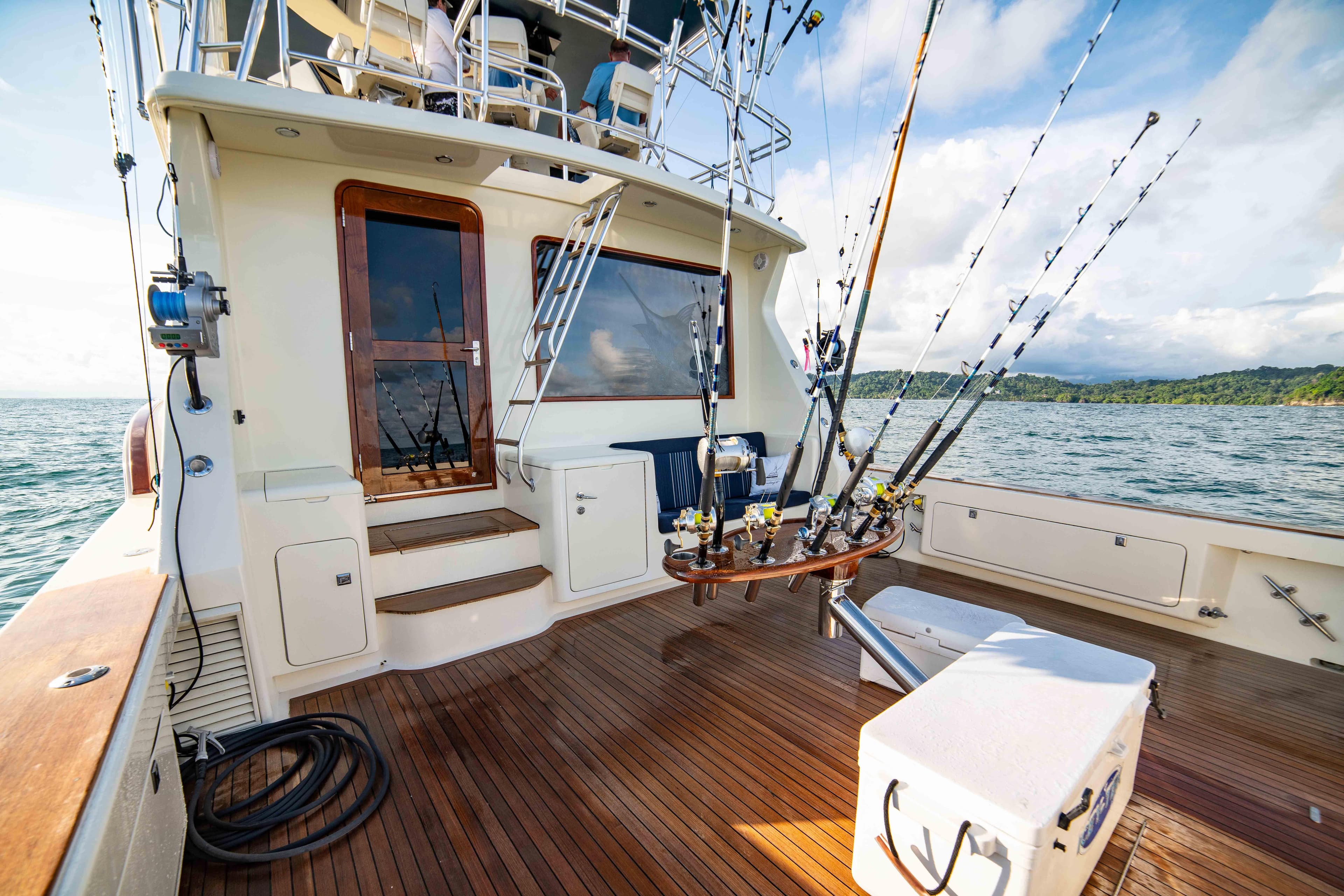 1996 Donzi 72 Custom Convertible yacht with fishing rods on deck.