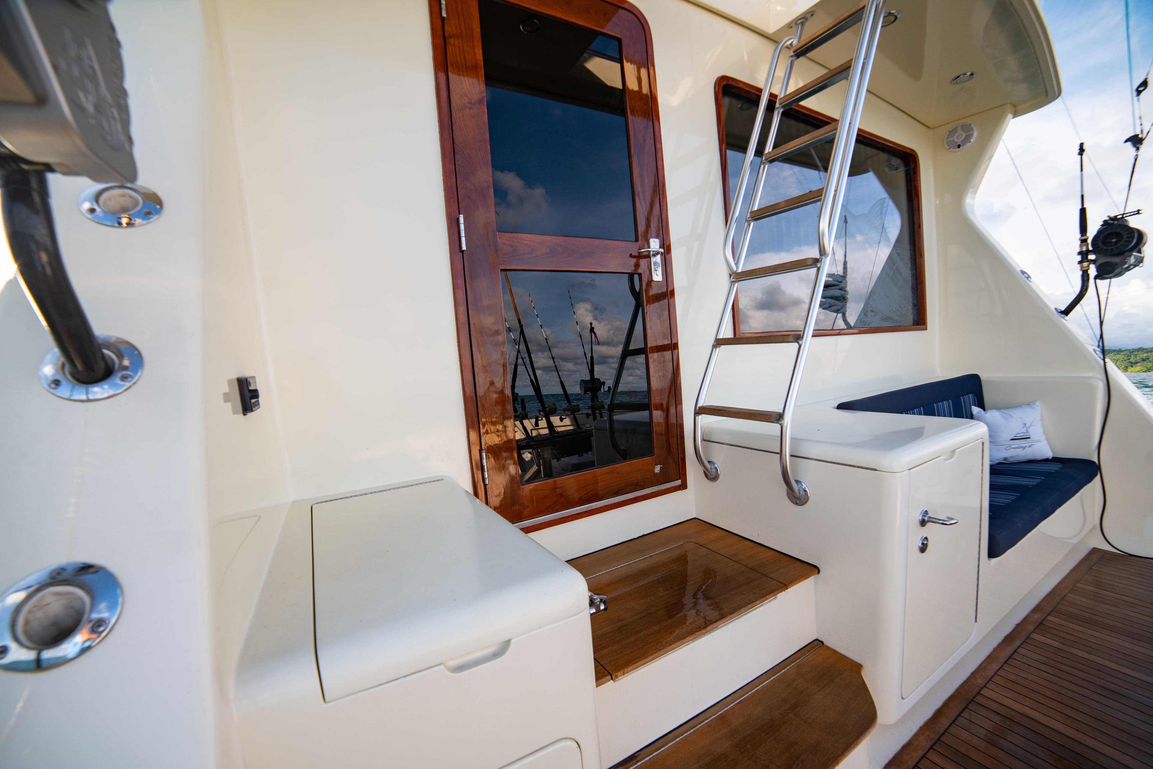 1996 Donzi 72 Custom Convertible yacht exterior with wooden door and ladder.