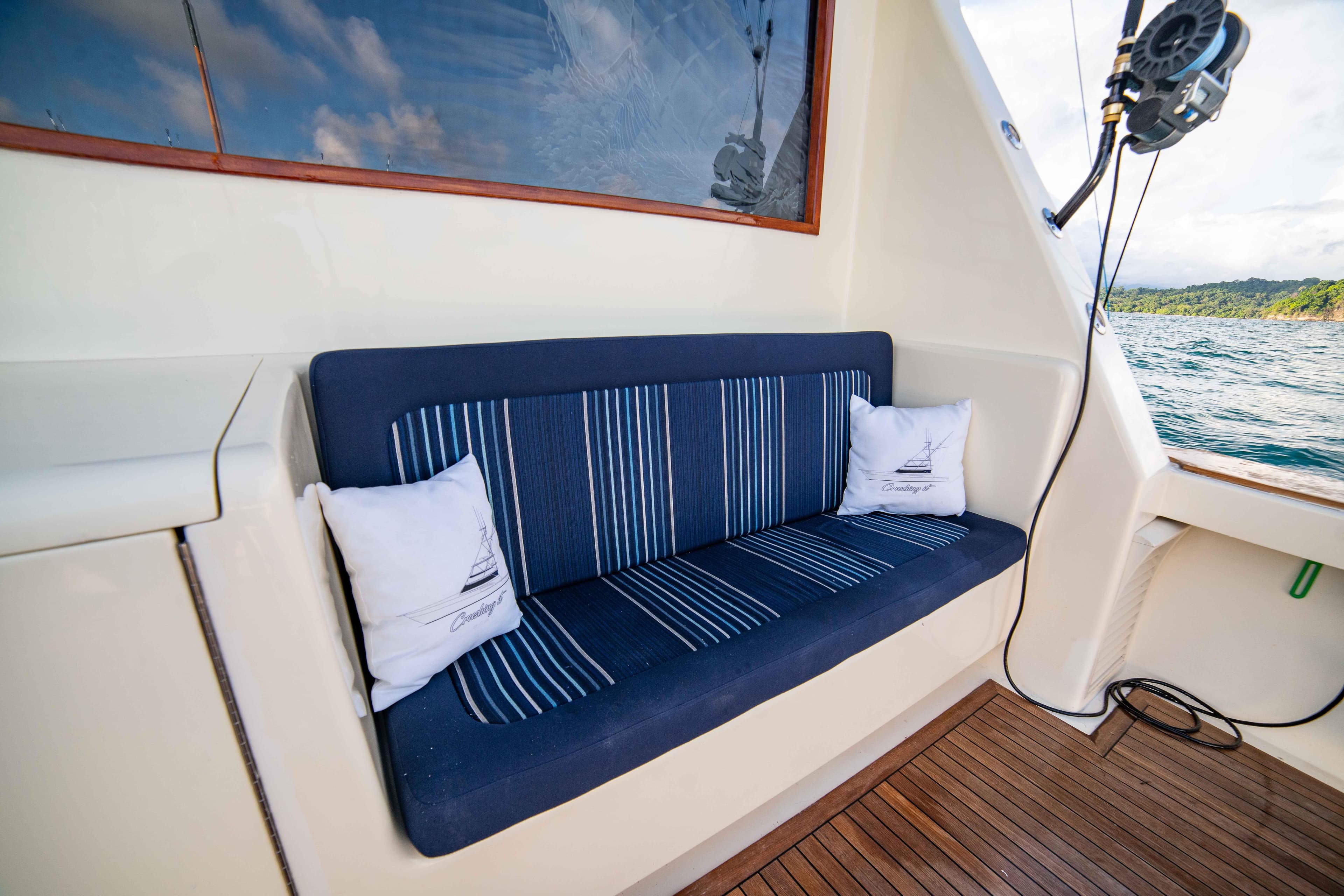 1996 Donzi 72 Custom Convertible boat interior with blue cushioned seating.