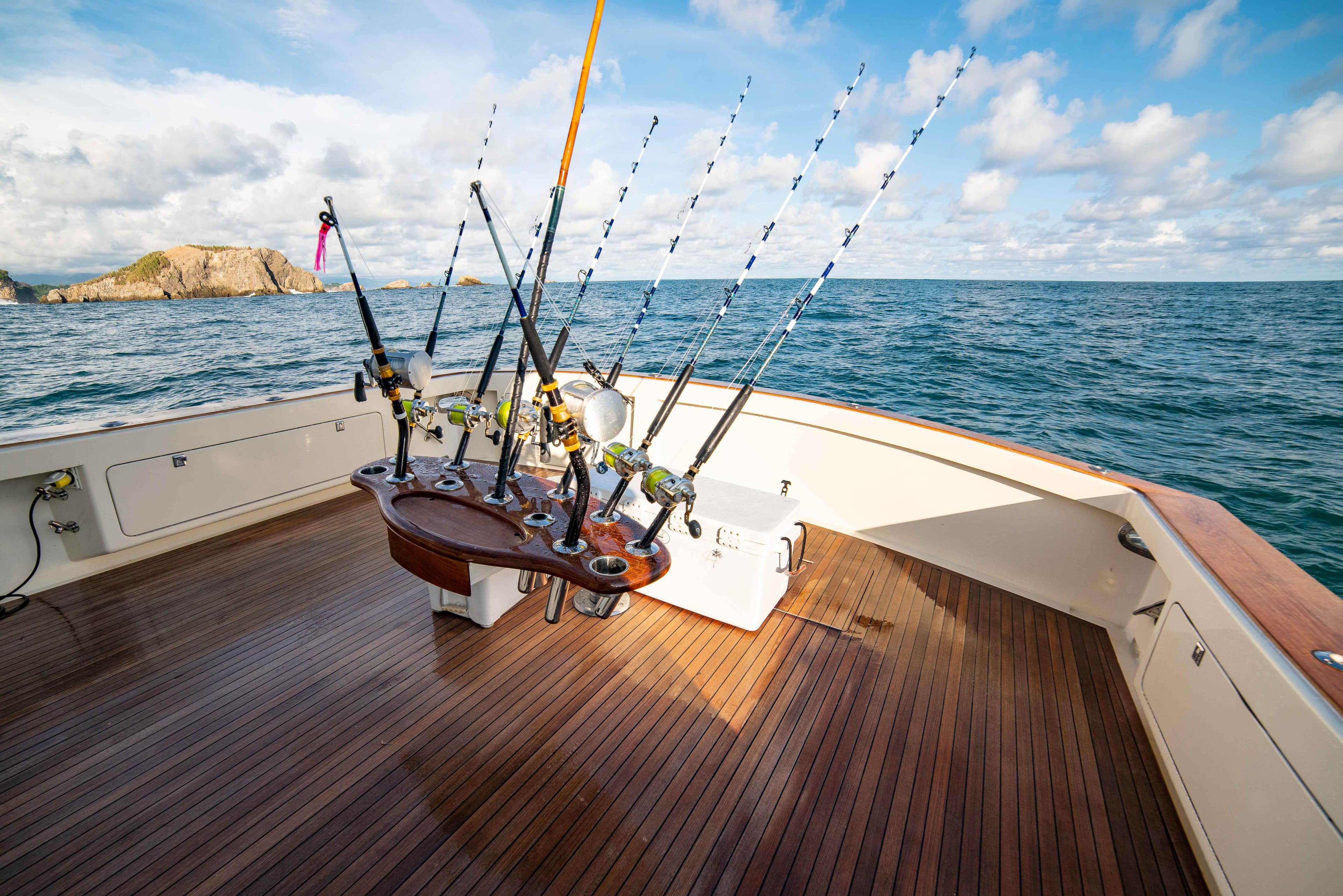 Fishing deck of a 1996 Donzi 72 Custom Convertible yacht with fishing rods.