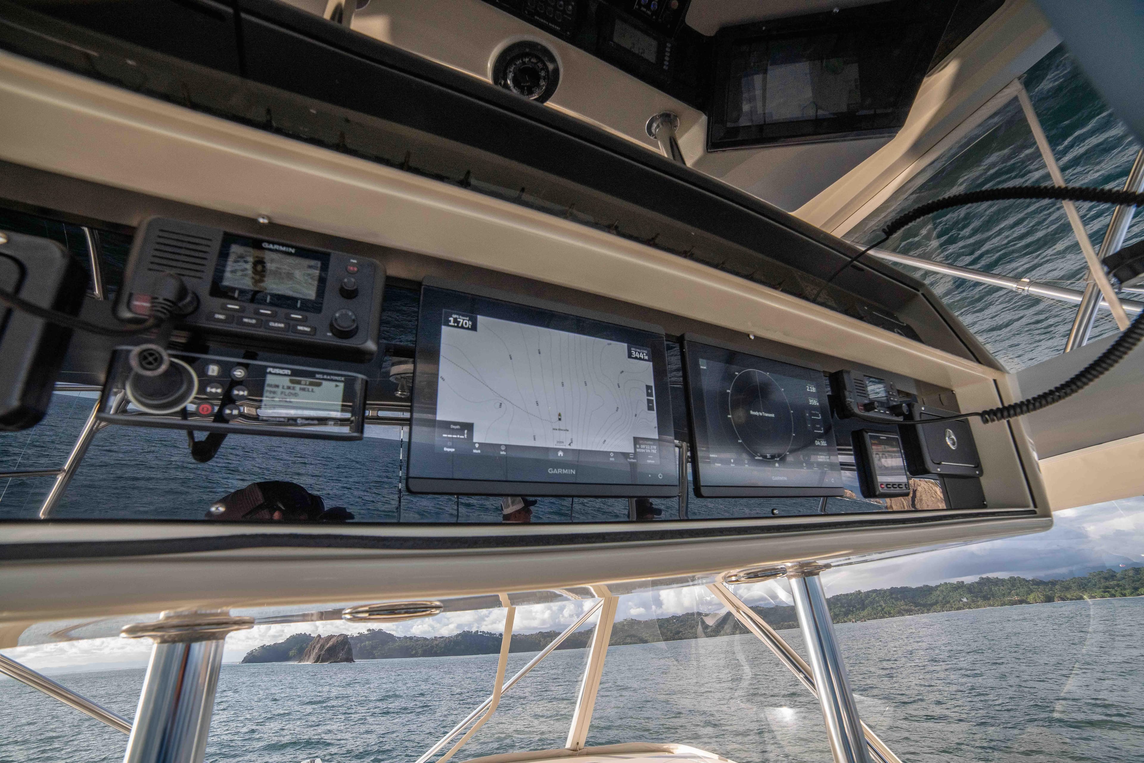 Control panel of a 1996 Donzi 72 Custom Convertible yacht with navigation screens.