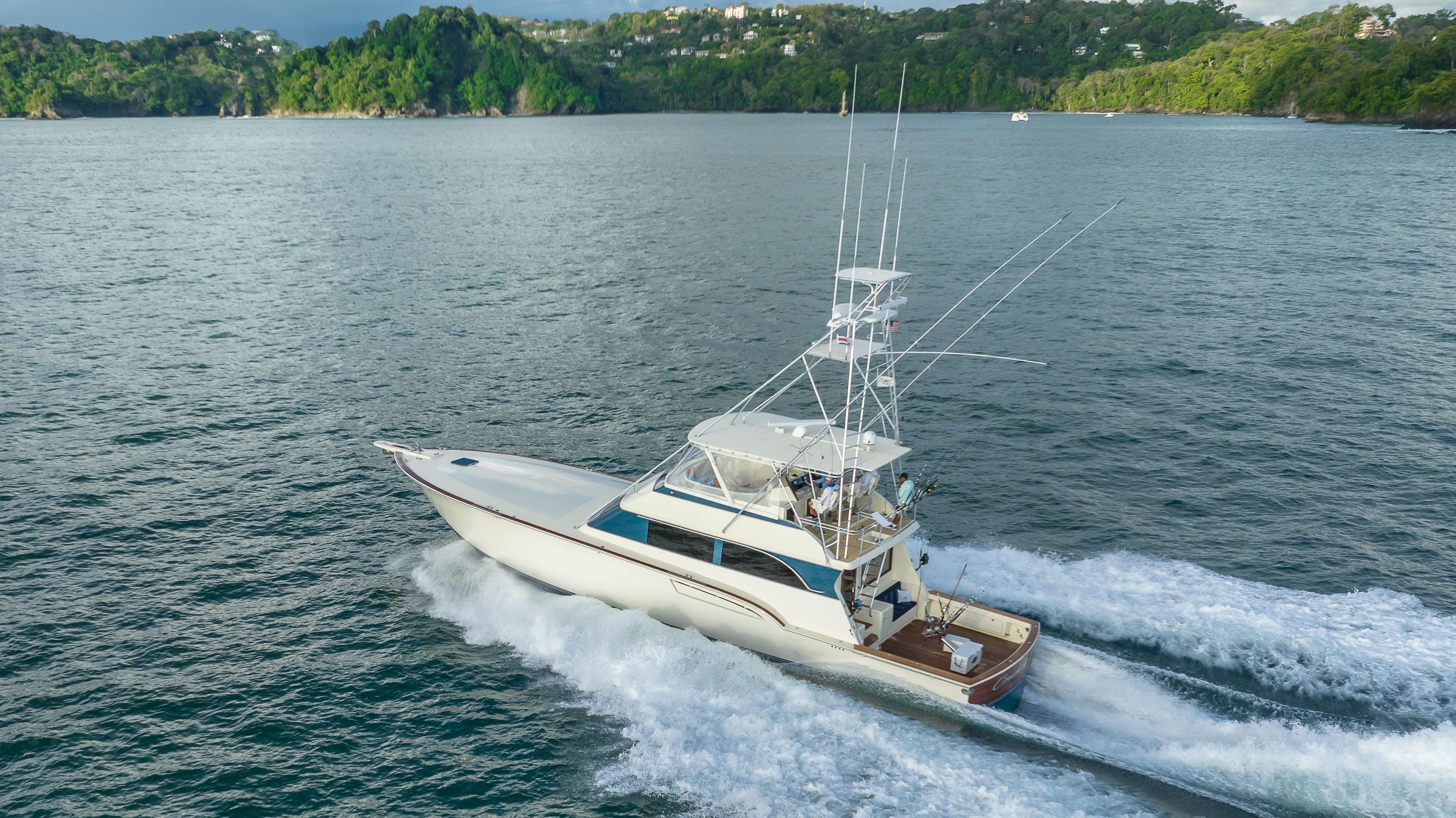 1996 Donzi 72 Custom Convertible yacht cruising on a scenic waterway.