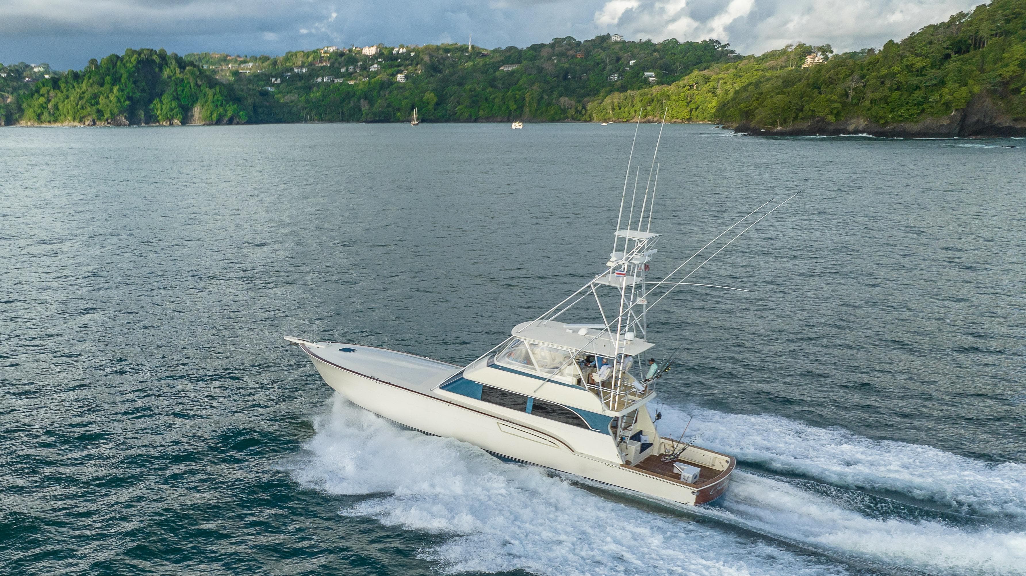 1996 Donzi 72 Custom Convertible yacht cruising on scenic waters.