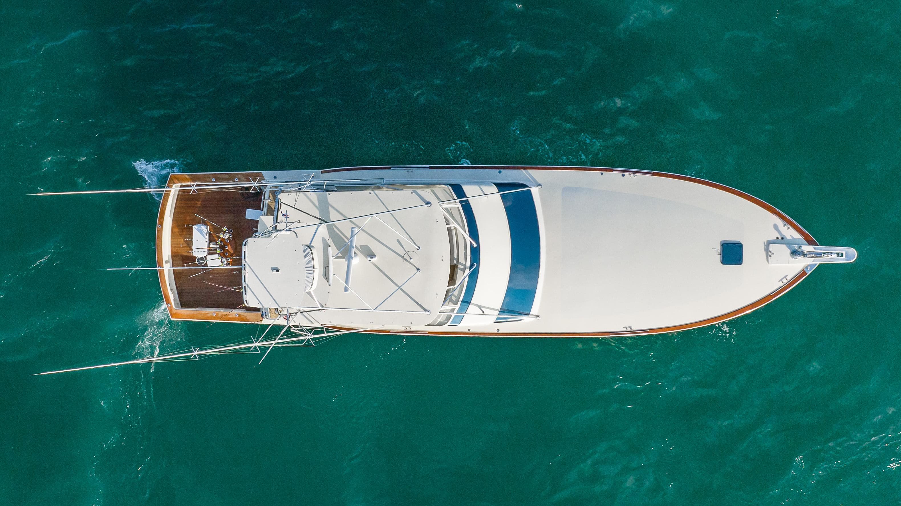Aerial view of a 1996 Donzi 72 Custom Convertible yacht on turquoise water.