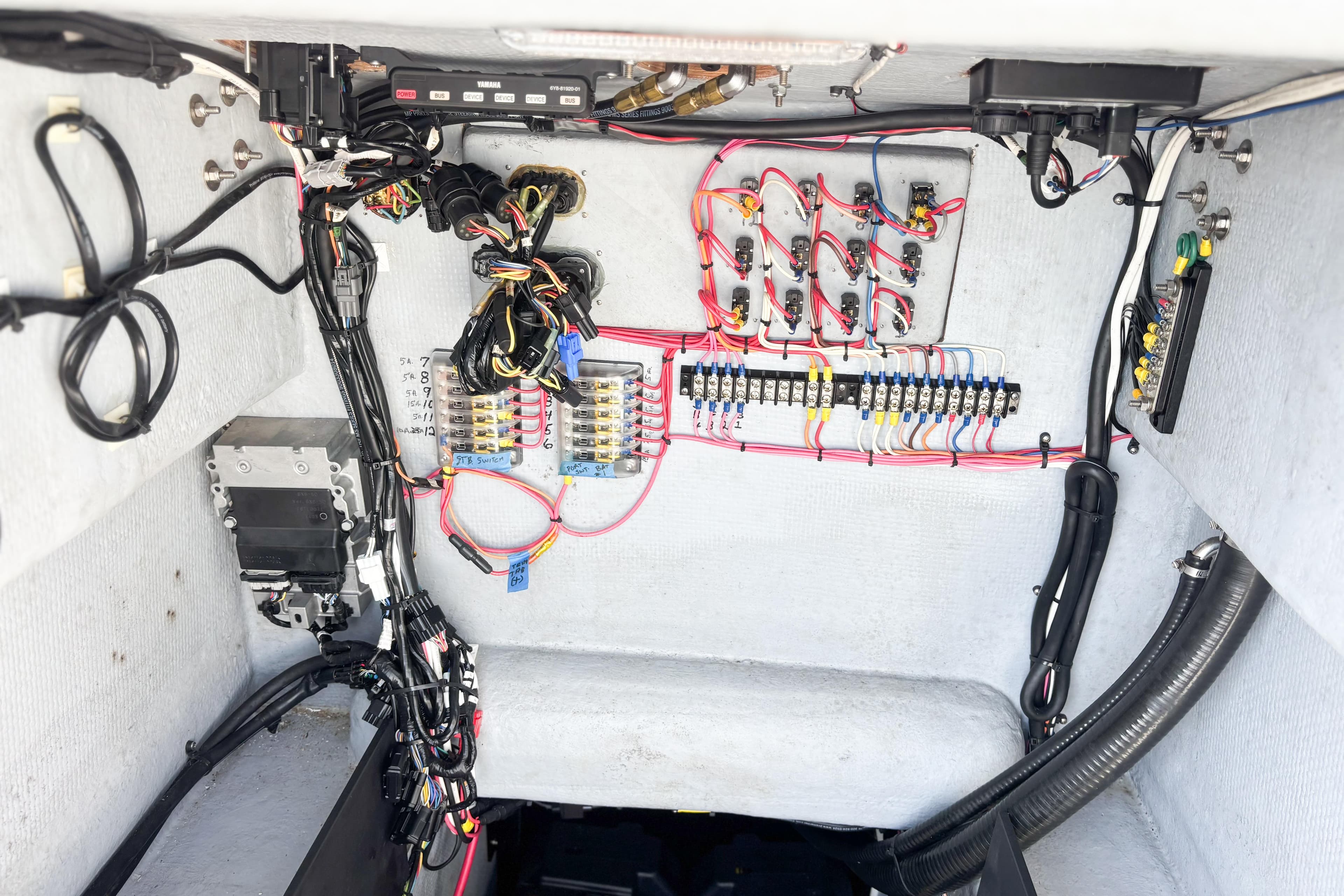 Electrical wiring system inside a 2016 Whitewater boat, showcasing organized cables and connectors.