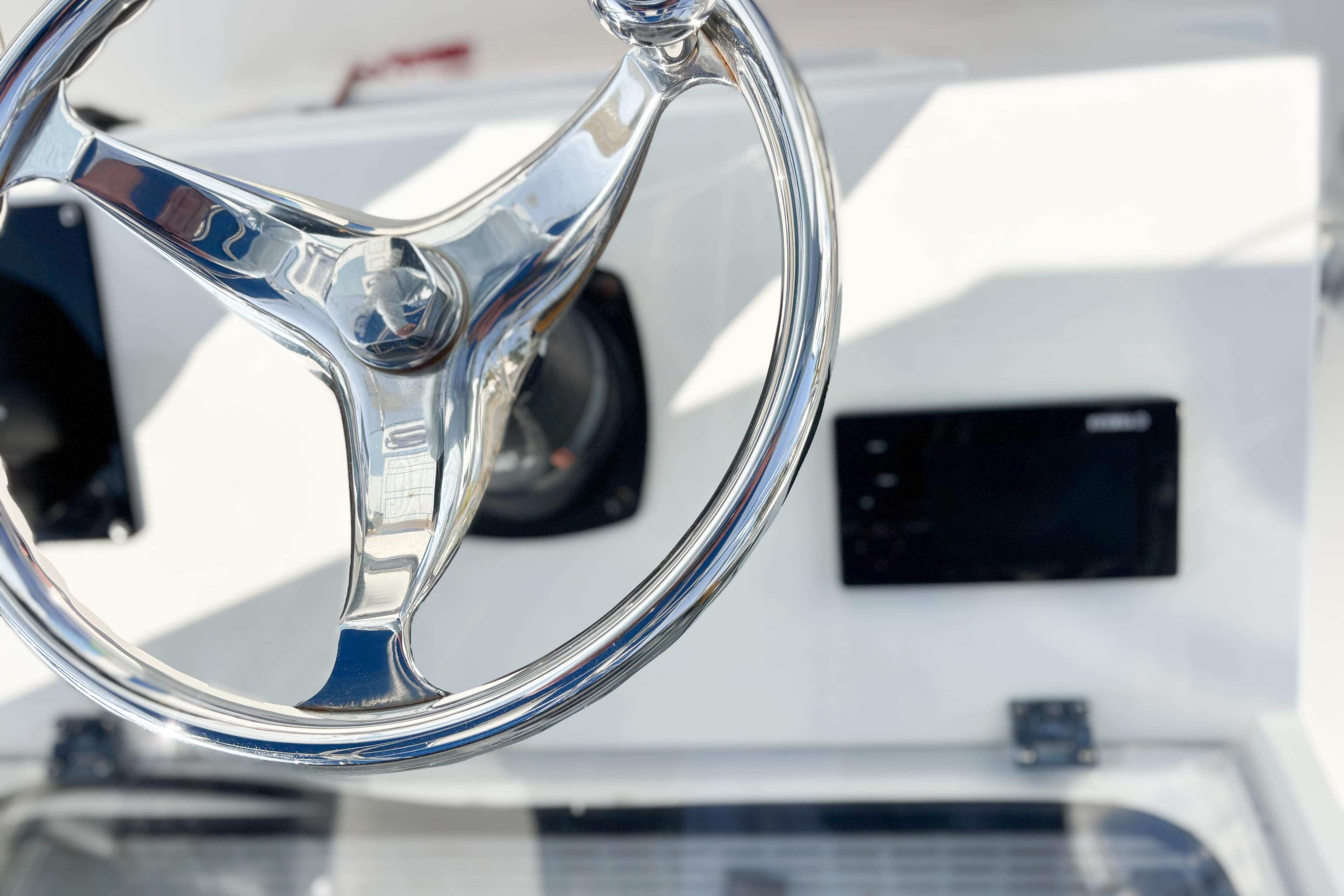 Chrome steering wheel on a 2016 Whitewater boat dashboard.