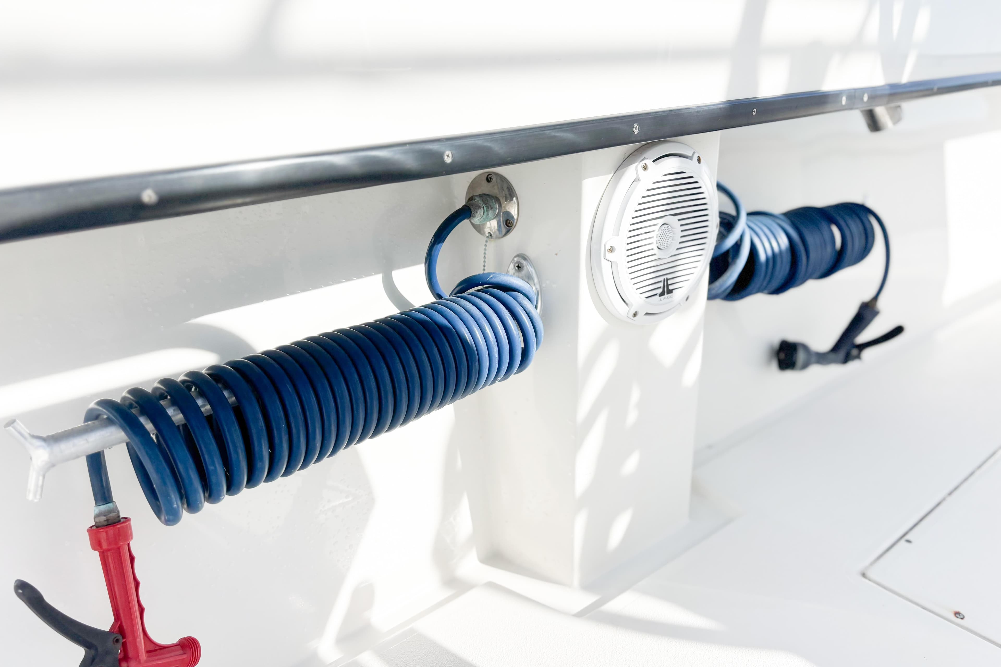 2016 Whitewater boat deck with coiled blue hose and speaker.