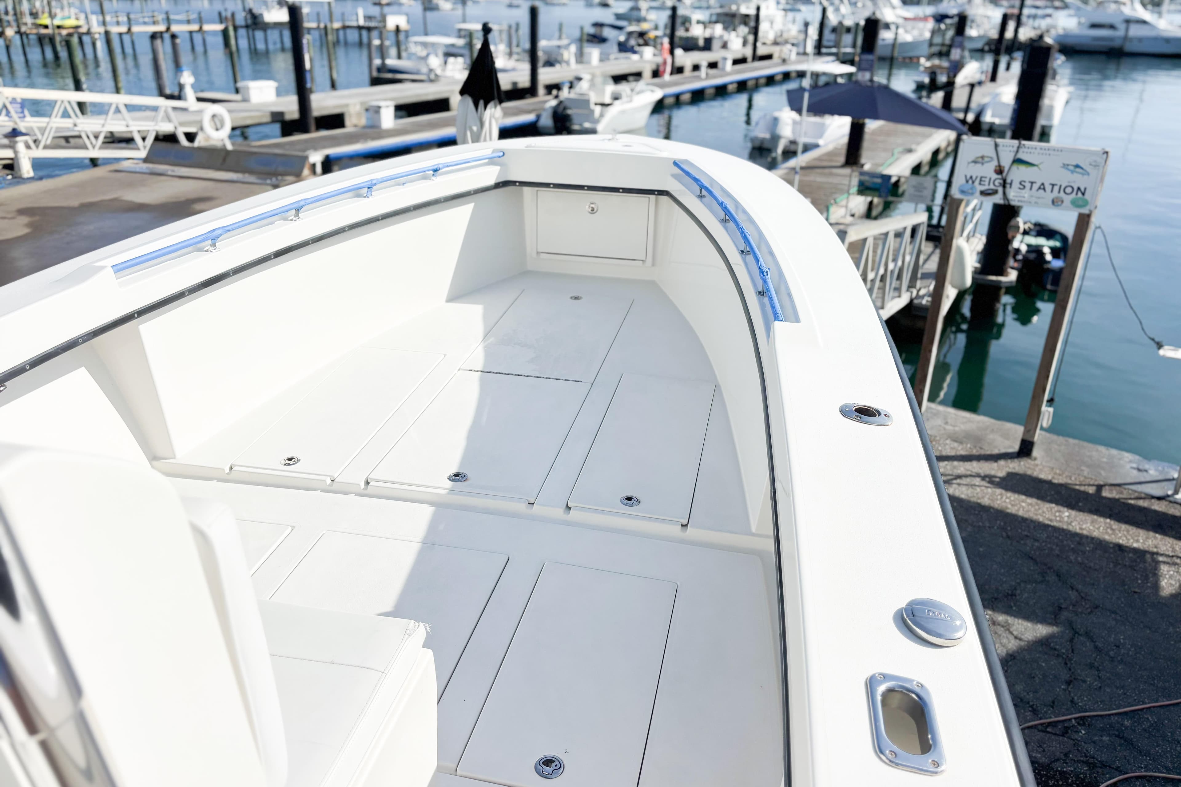 Whitewater 2016 boat at marina, featuring spacious deck and sleek design.