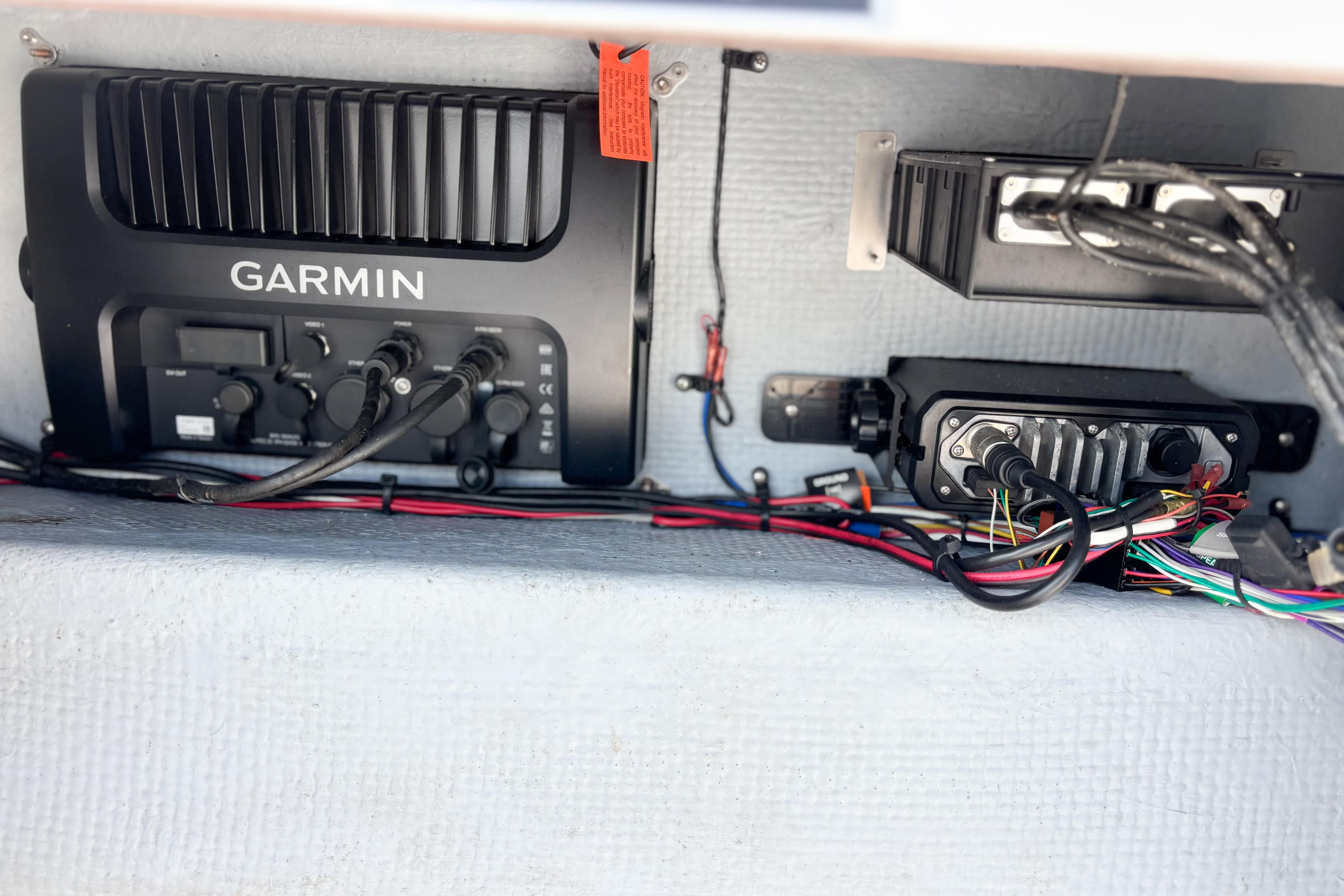 Garmin marine electronics setup in a 2016 Whitewater boat, featuring wiring and connectors.