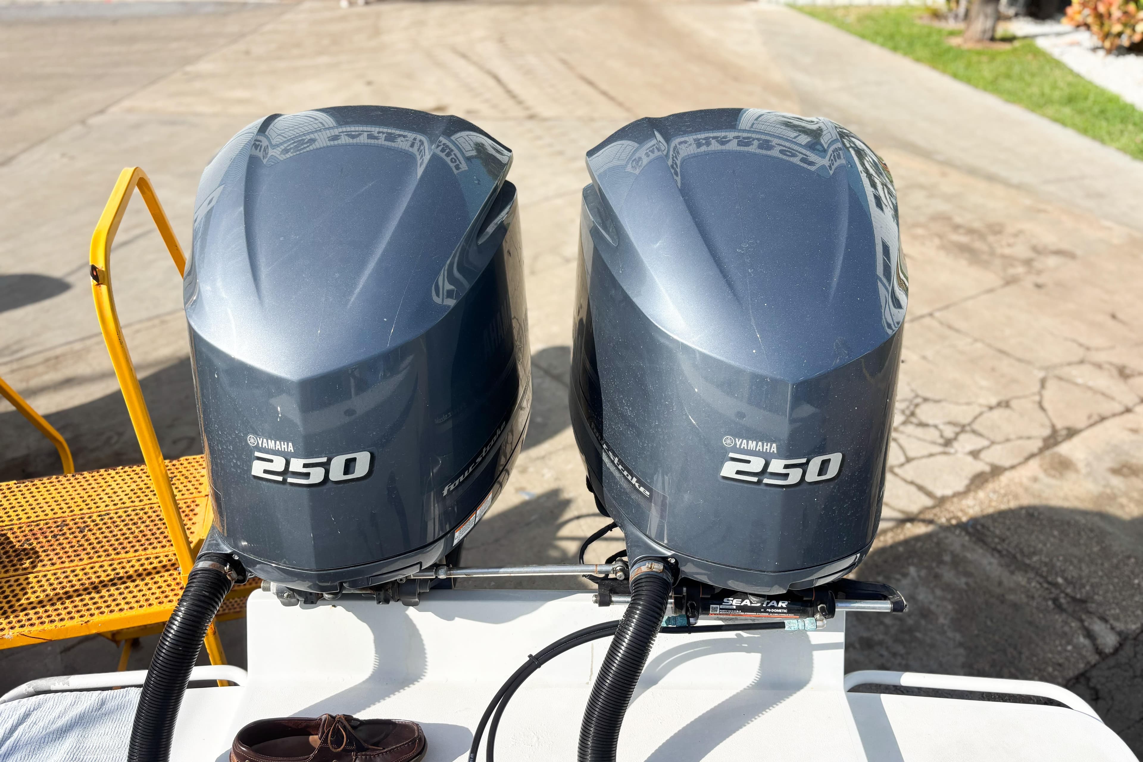 Twin Yamaha 250 outboard motors on a 2016 Whitewater boat, dockside view.