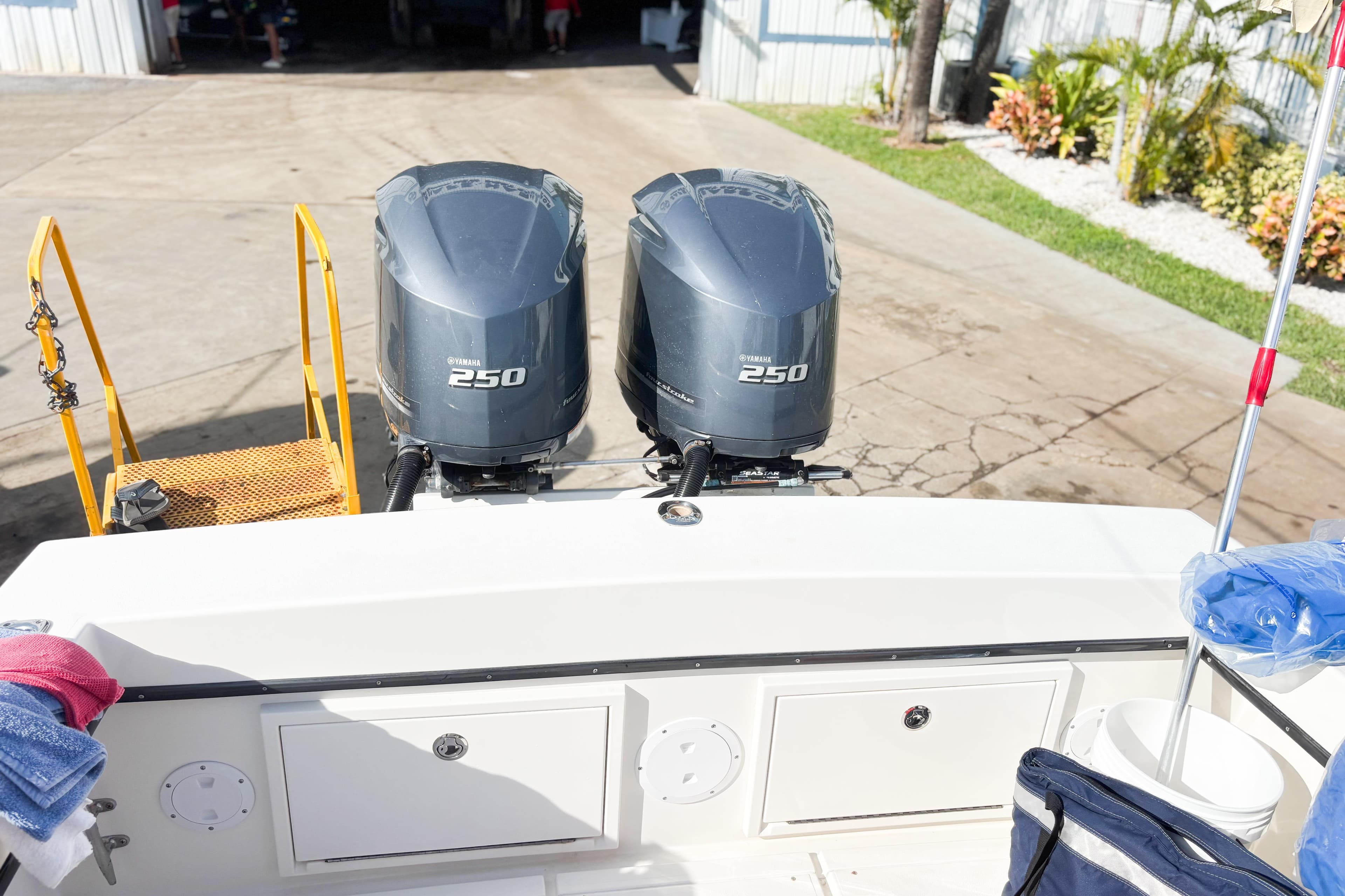 Twin Yamaha 250 outboard engines on a 2016 Whitewater boat, docked with equipment.