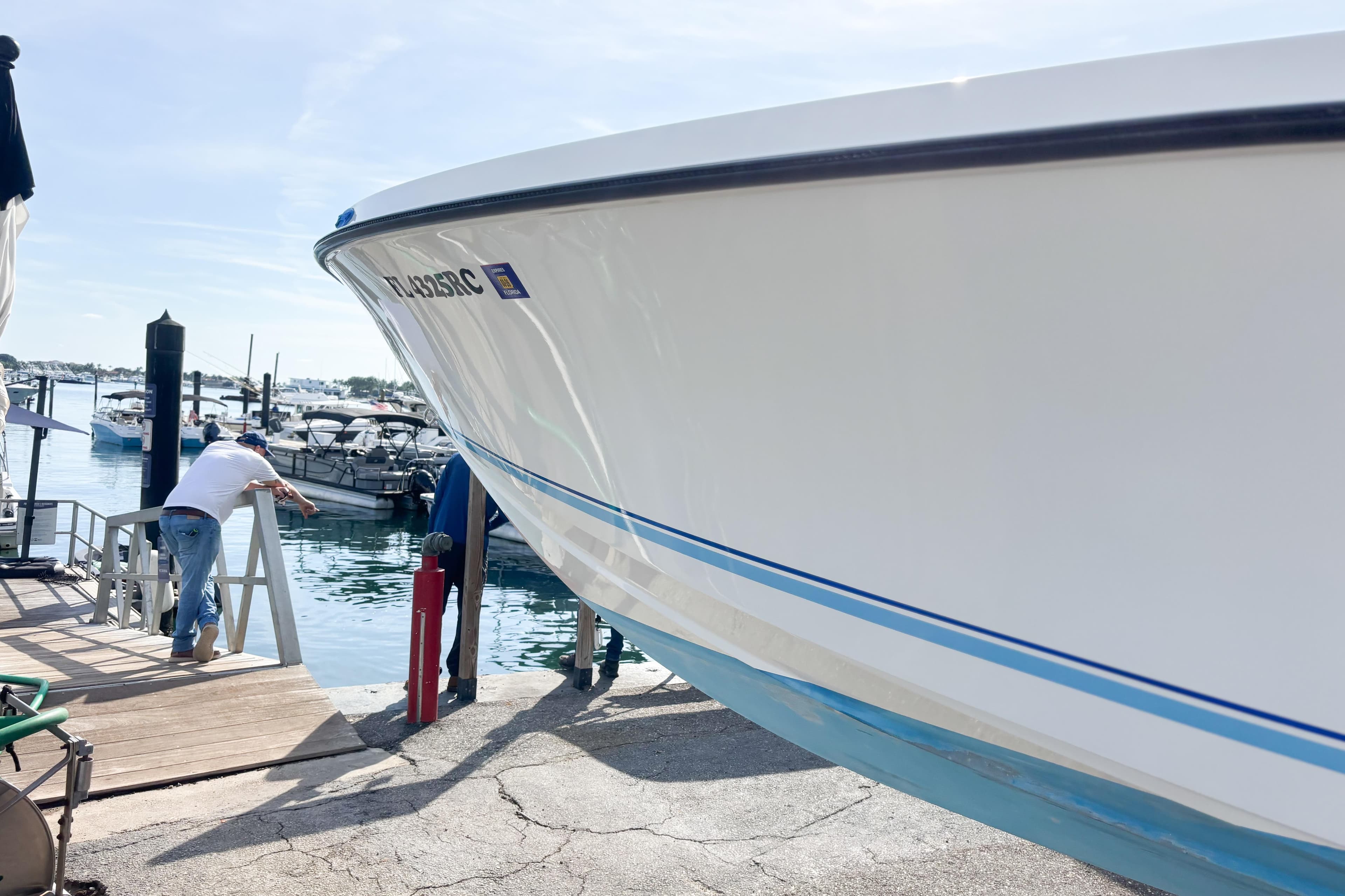 Whitewater boat docked at marina, 2016 model, with person adjusting ropes.