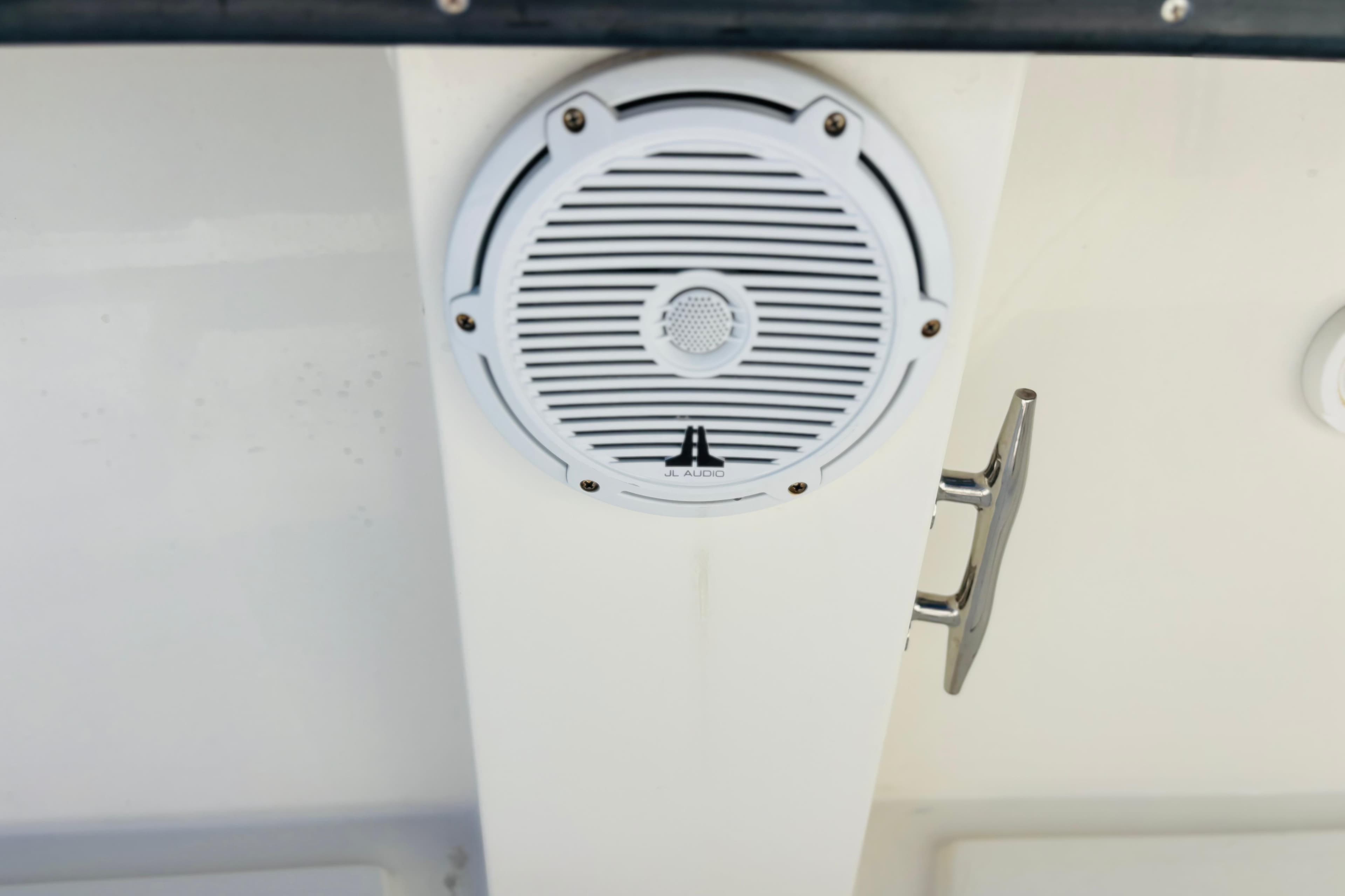 Whitewater 2016 boat speaker and handle on white surface.