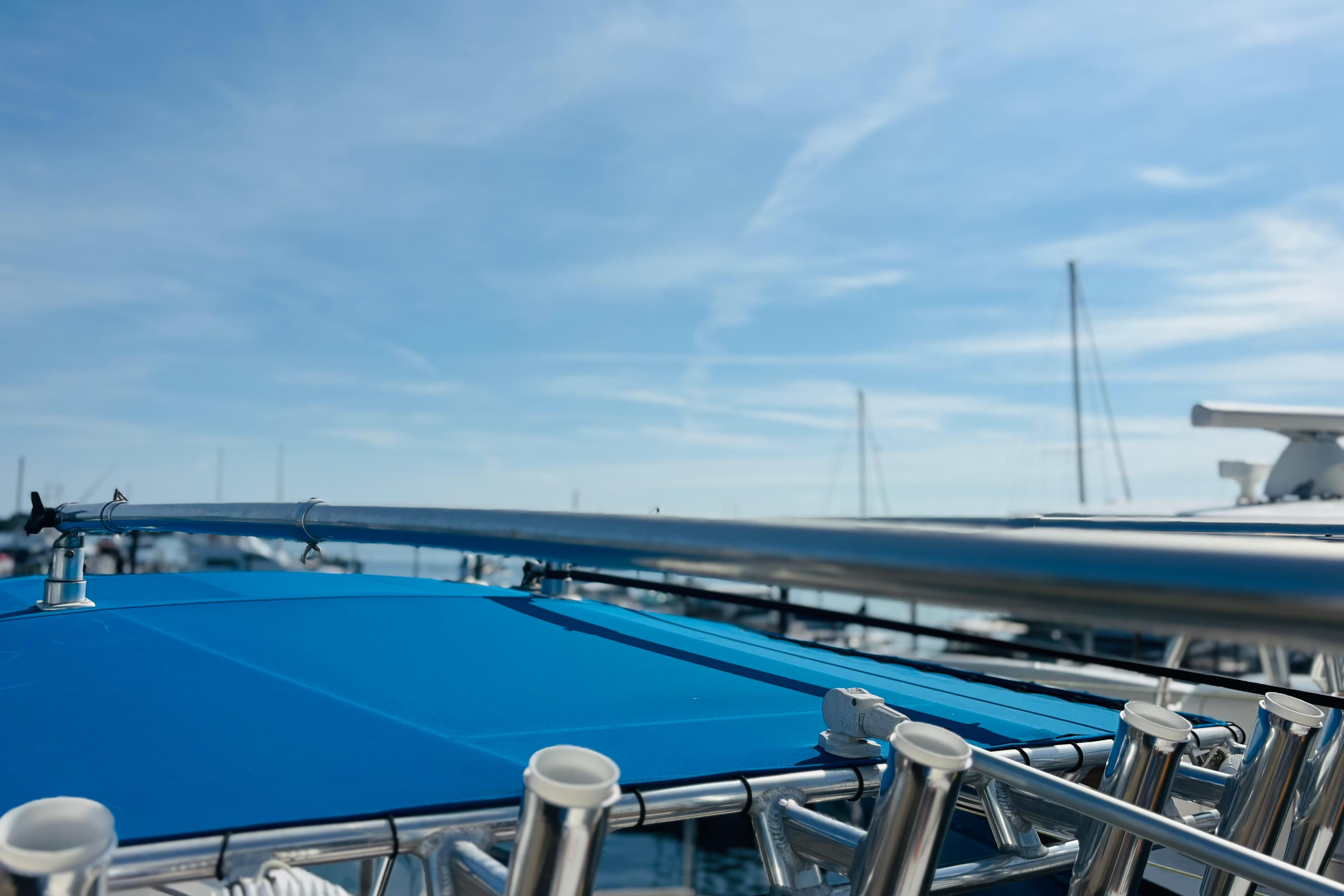 Blue canopy on a 2016 Whitewater boat under a clear sky.
