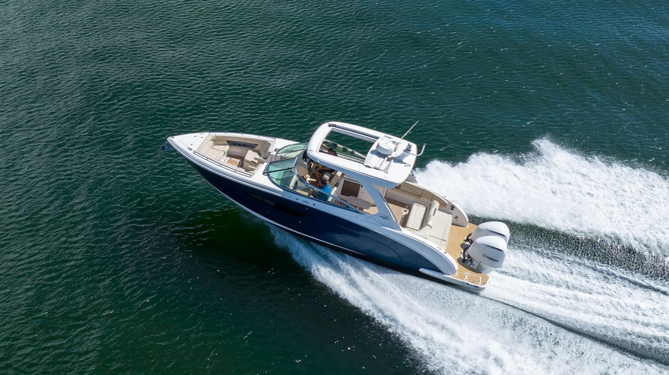 2019 Regal 33 OBX boat cruising swiftly on open water.