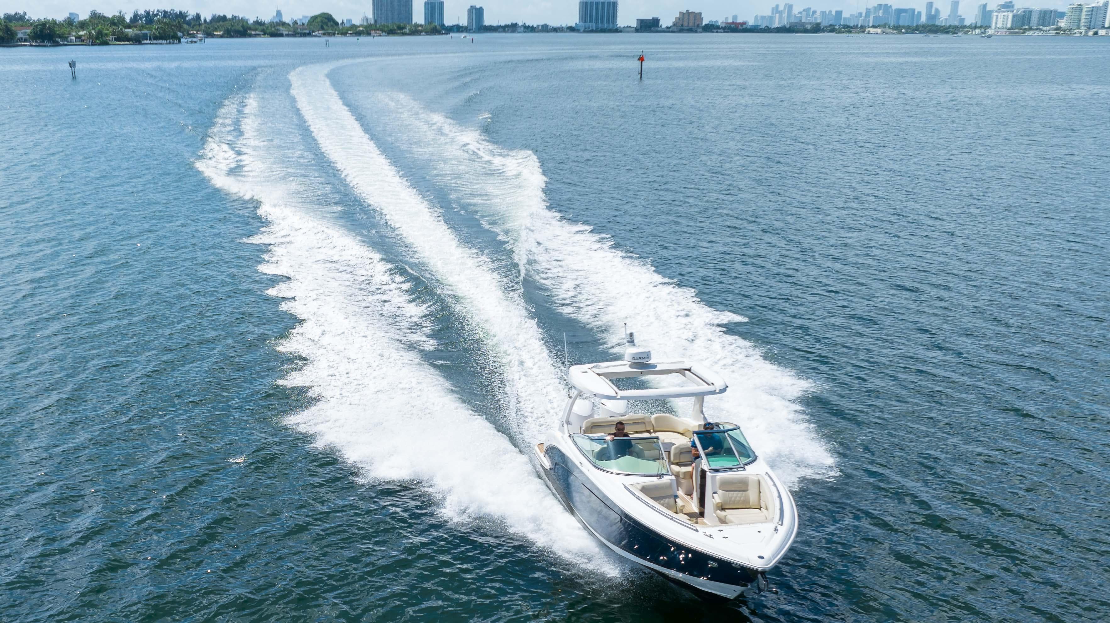 2019 Regal 33 OBX boat cruising on open water, leaving a wake behind.