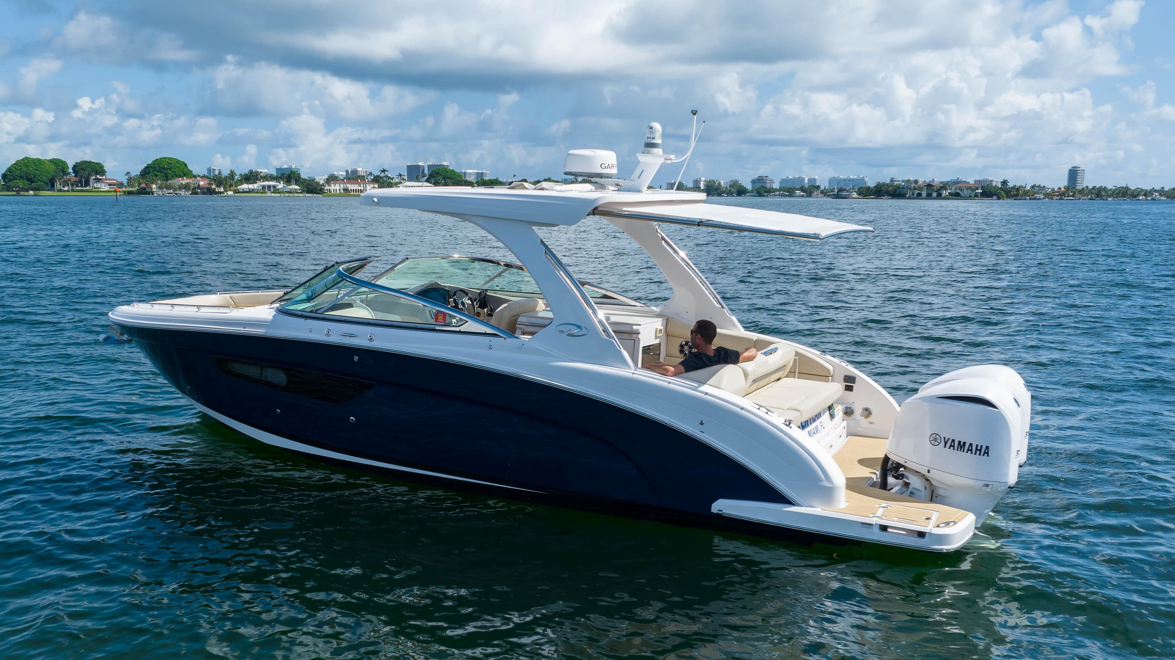 2019 Regal 33 OBX boat cruising on a sunny day with Yamaha engines.