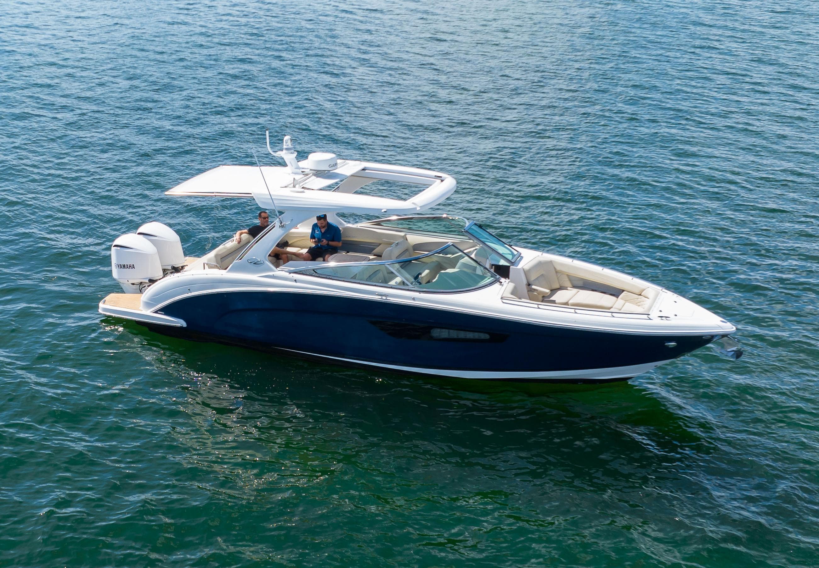 2019 Regal 33 OBX boat cruising on open water, featuring sleek design and spacious seating.