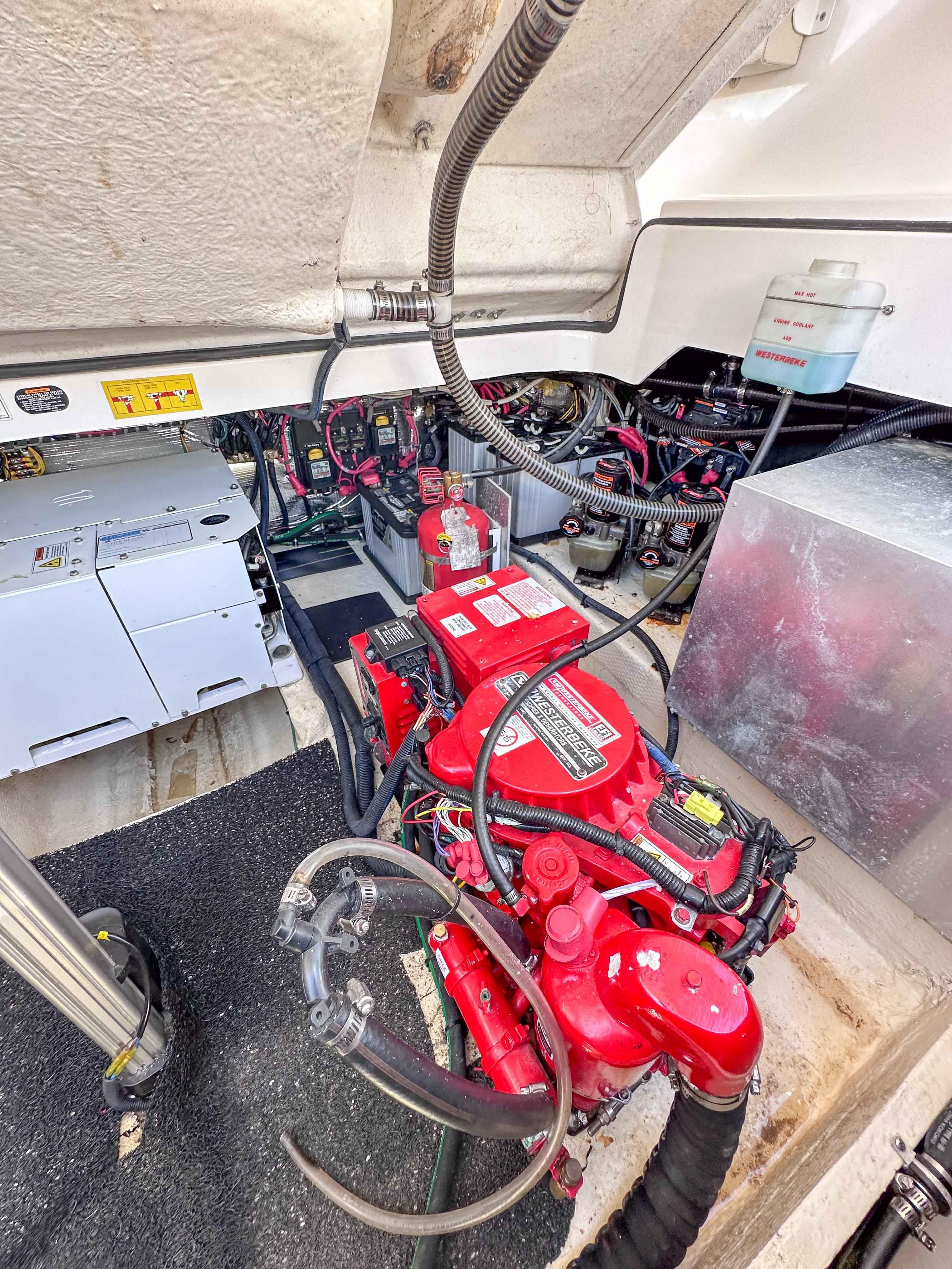 Engine compartment of a 2019 Regal 33 OBX boat, showcasing red engine and wiring.