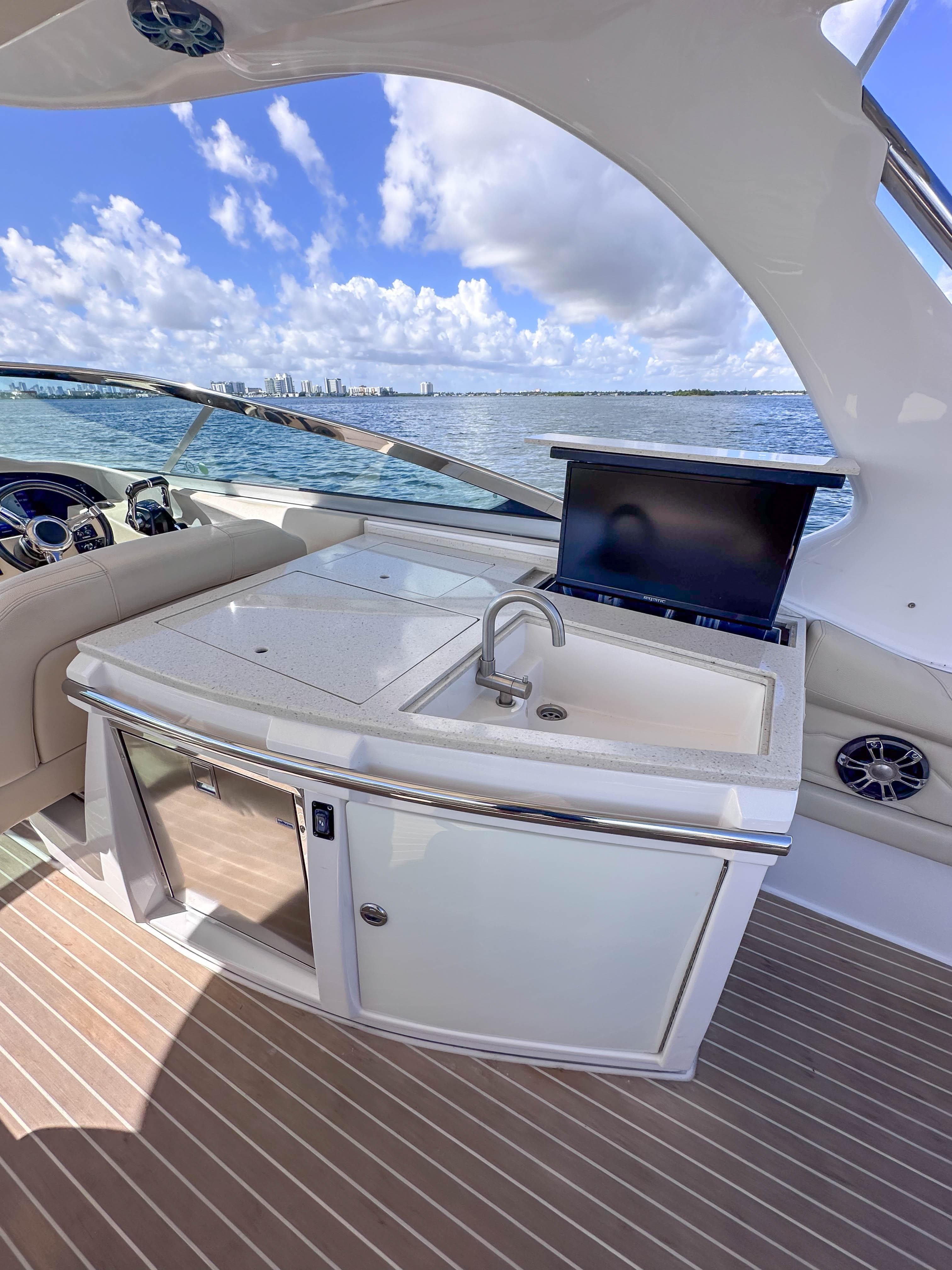 2019 Regal 33 OBX yacht interior with kitchenette and ocean view.
