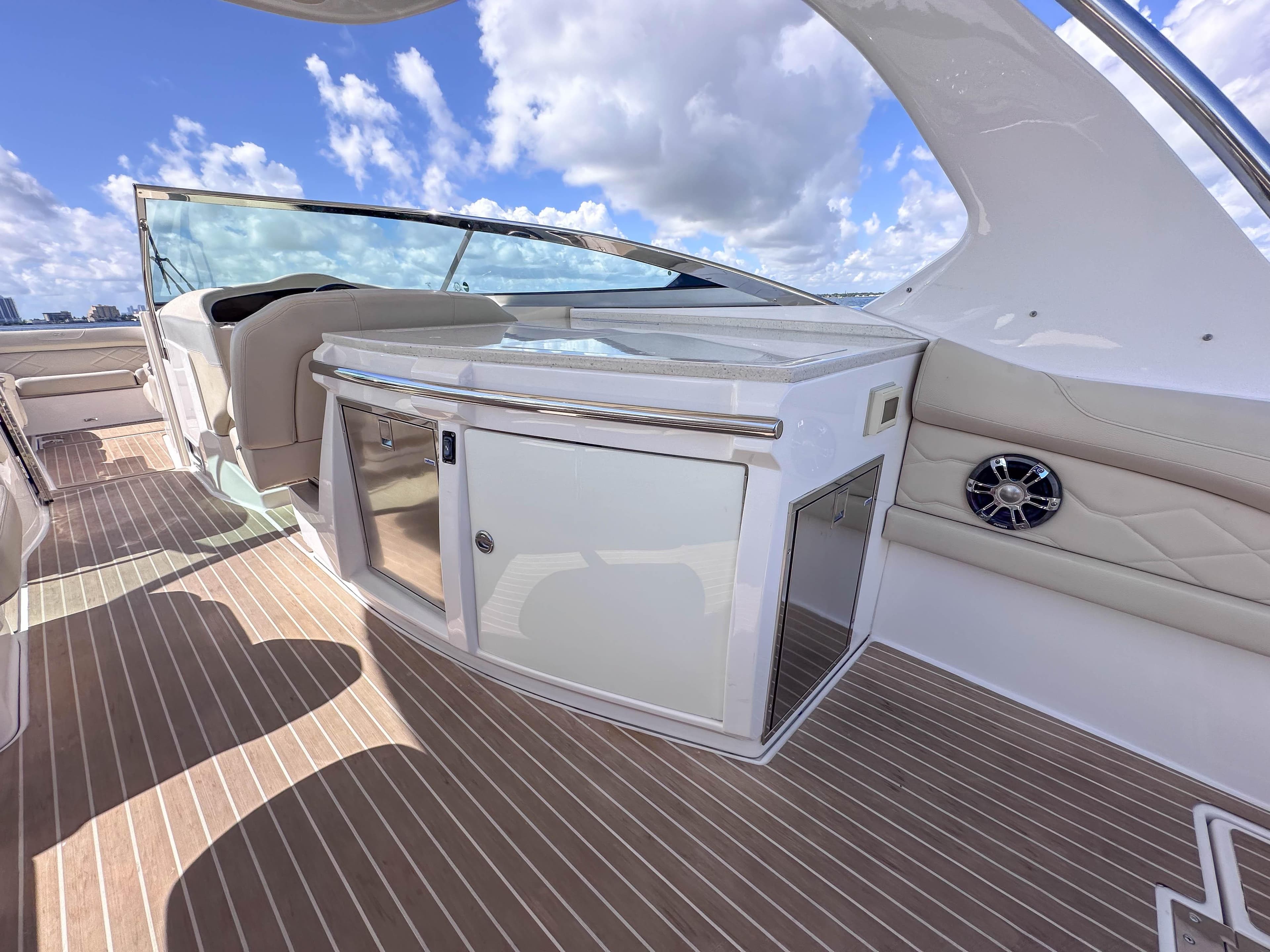 2019 Regal 33 OBX boat interior with sleek cabinetry and seating under a blue sky.