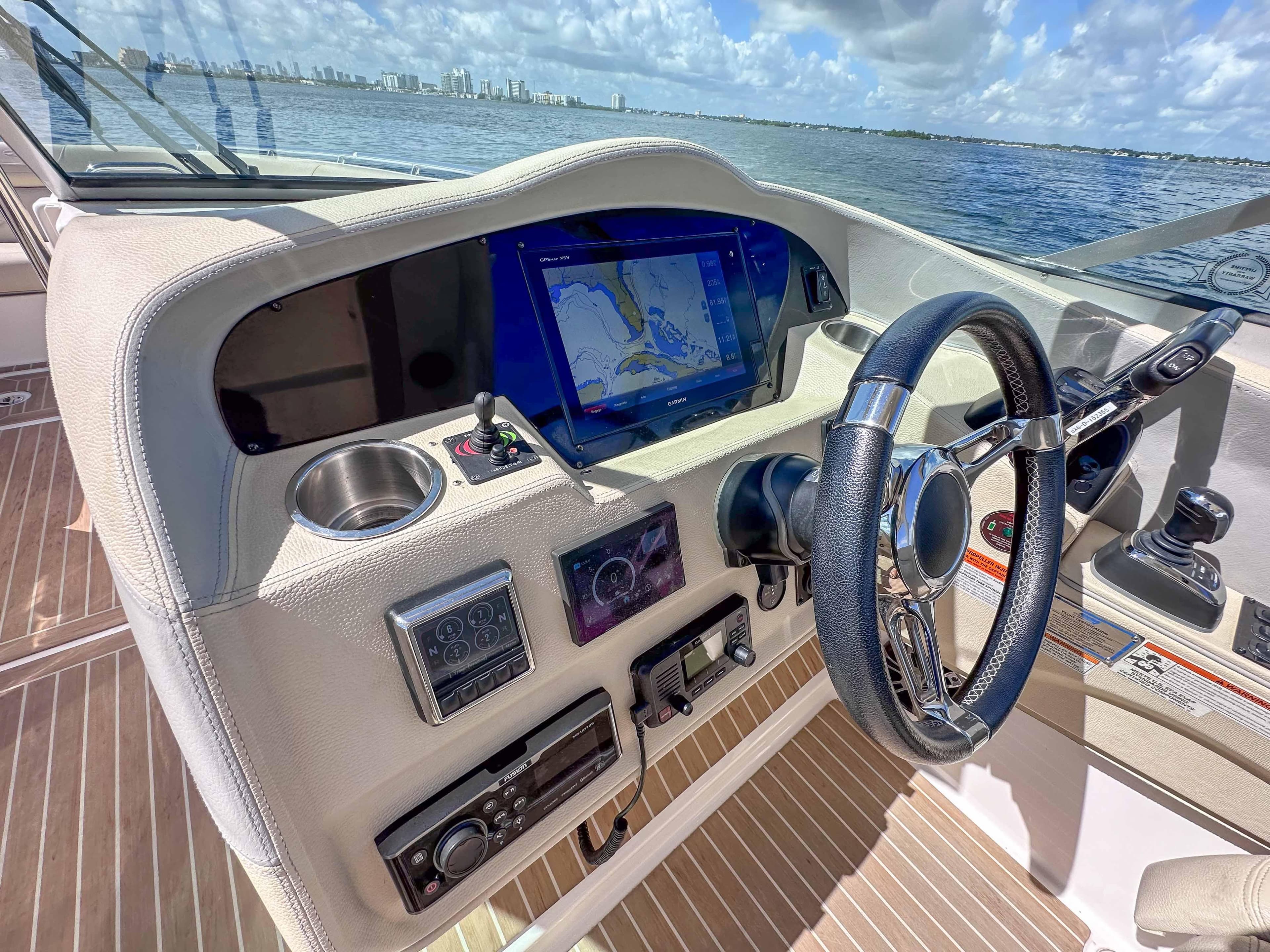 2019 Regal 33 OBX boat dashboard with navigation screen, steering wheel, and controls.