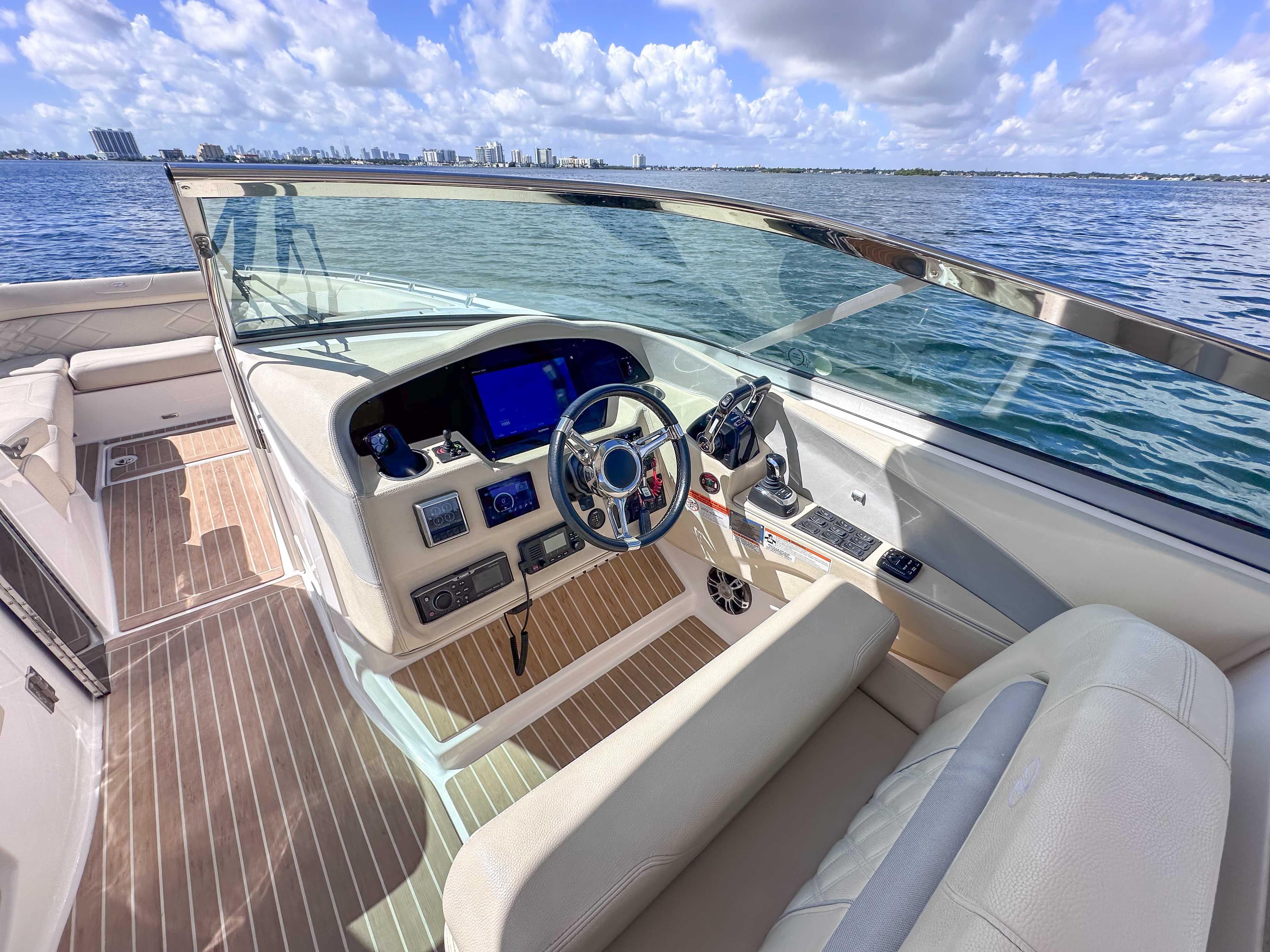 2019 Regal 33 OBX boat cockpit with modern controls, steering wheel, and ocean view.