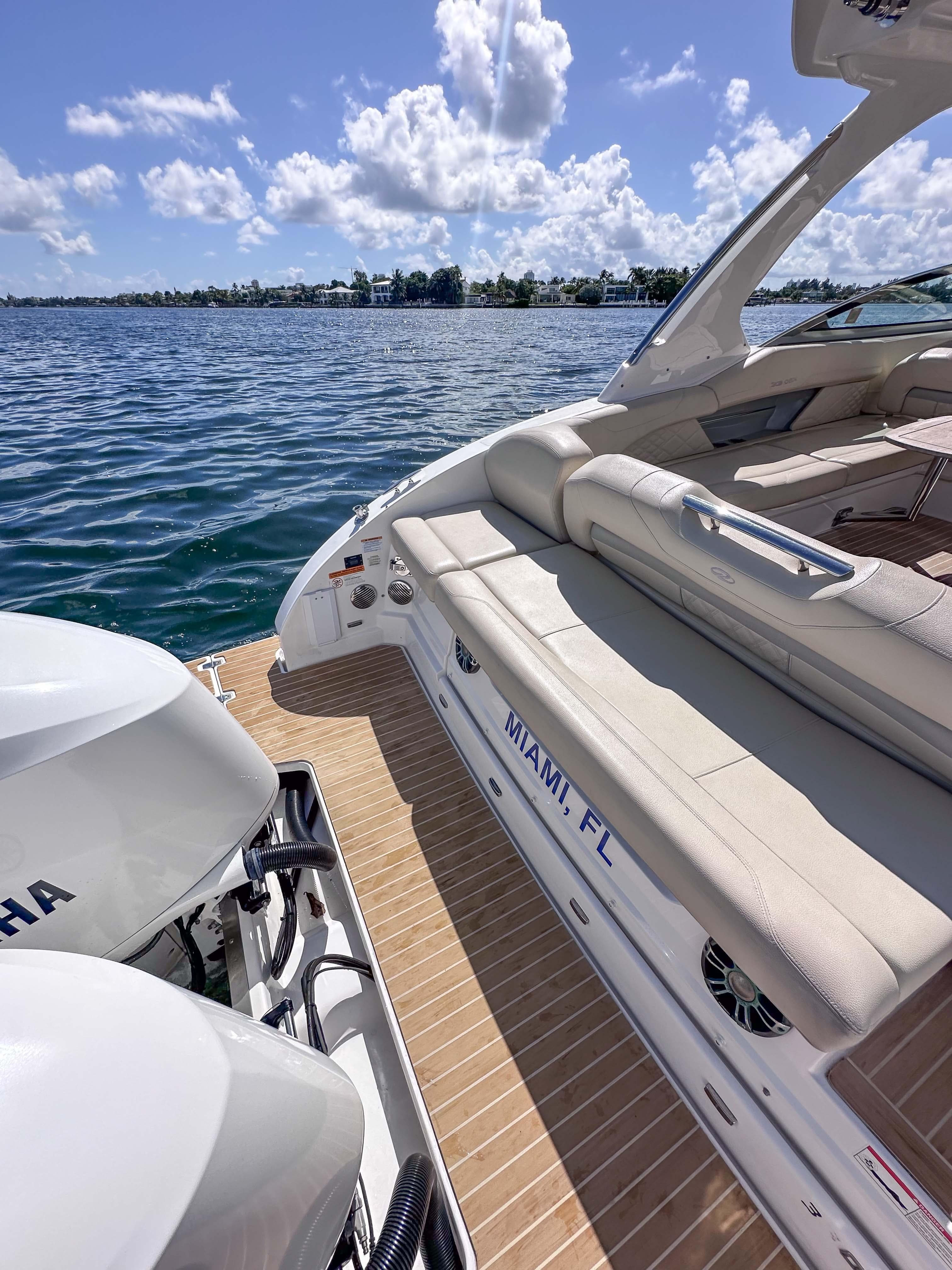 2019 Regal 33 OBX boat with Yamaha engines, docked in Miami, FL, on a sunny day.