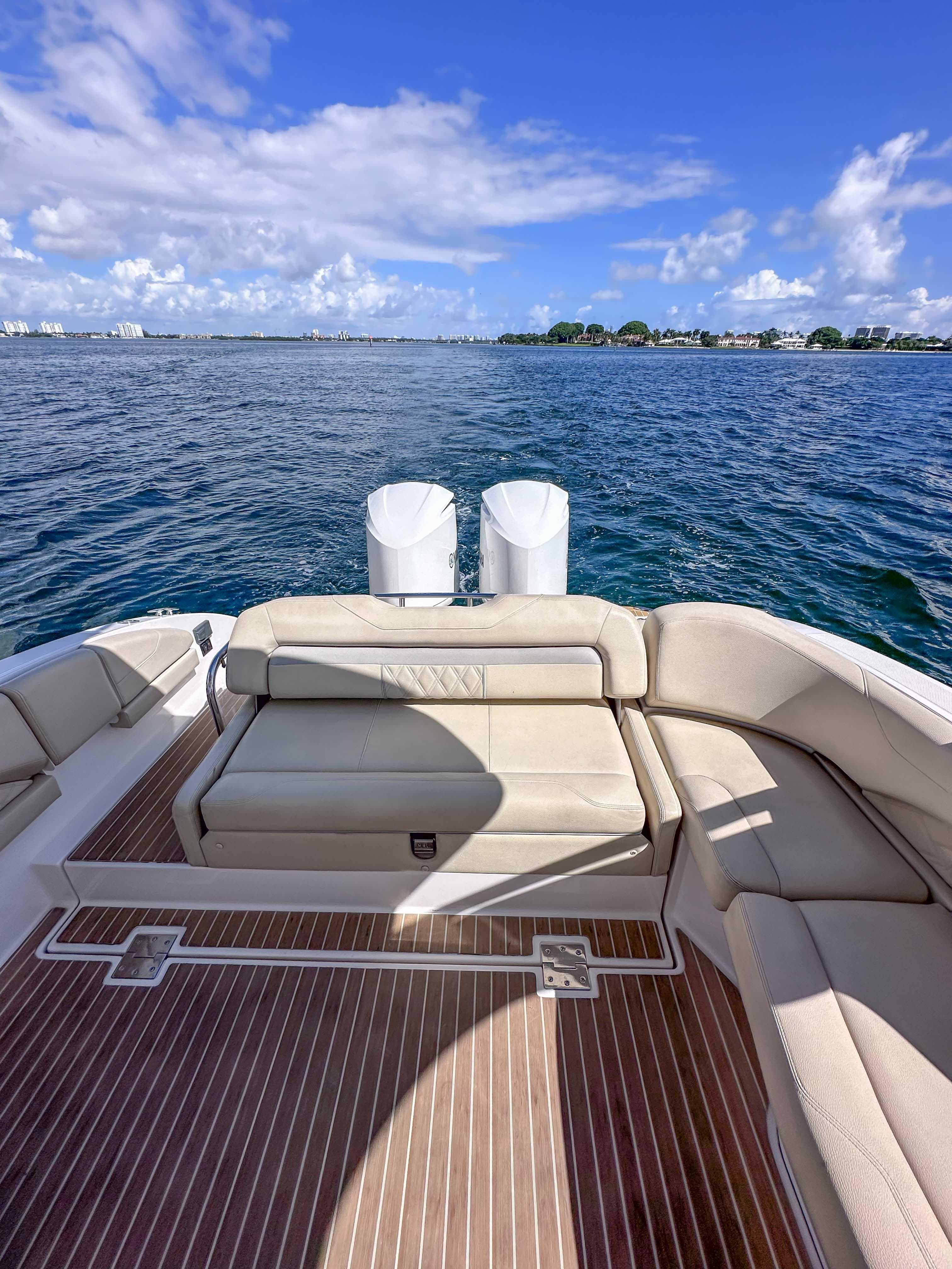 2019 Regal 33 OBX boat with spacious deck and seating, overlooking calm blue waters.