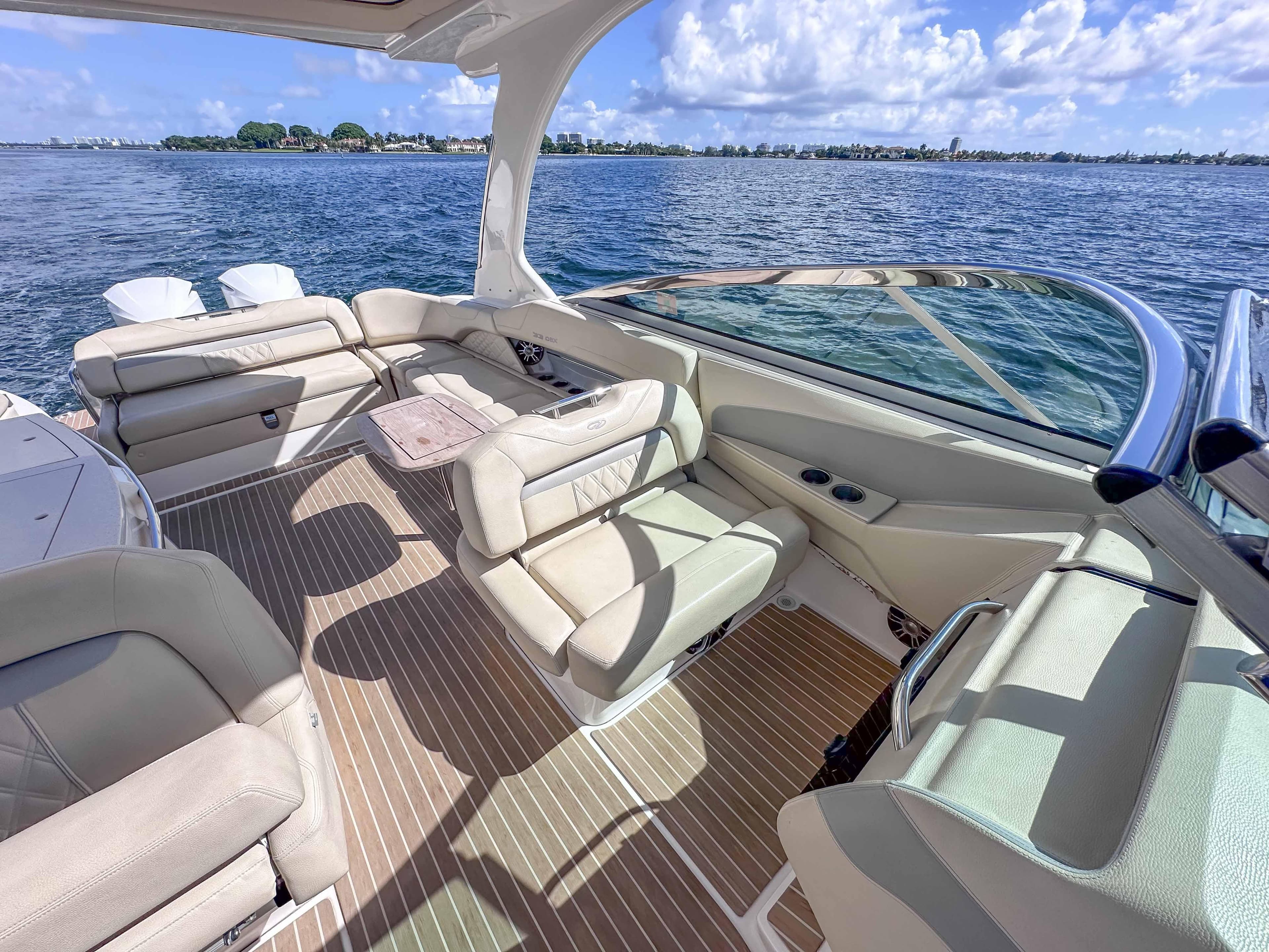 Luxurious 2019 Regal 33 OBX boat interior with beige seating and scenic ocean view.