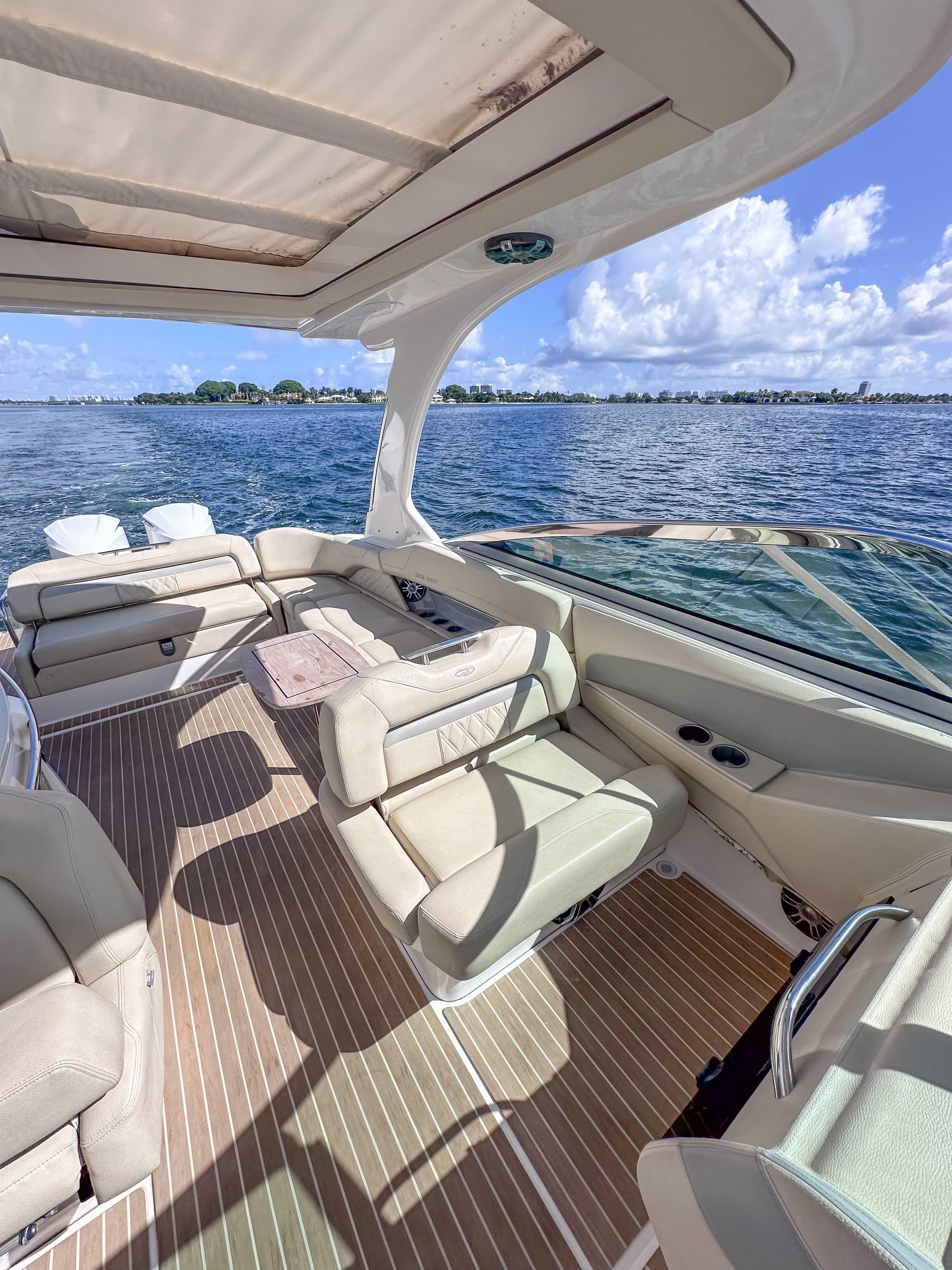 2019 Regal 33 OBX boat interior with luxurious seating, open water view, and sunny skies.