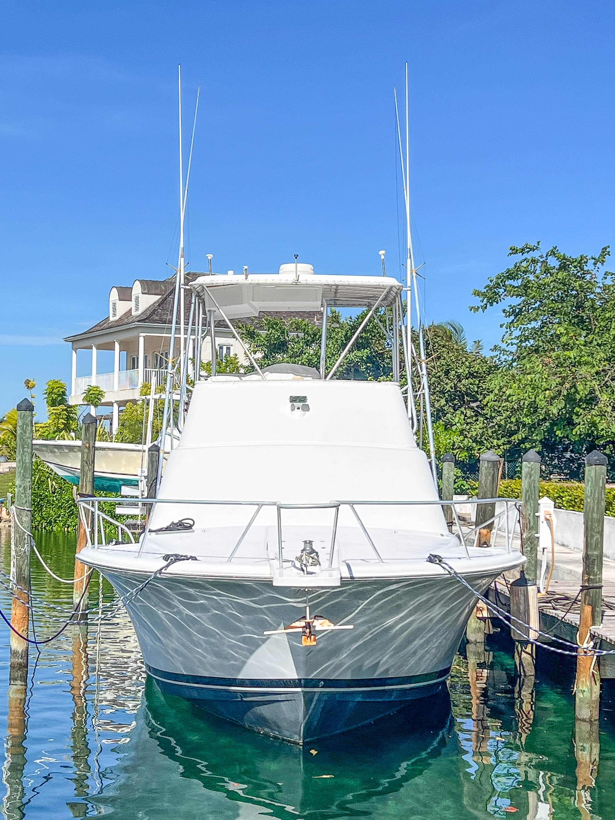 2000 Luhrs 400 Convertible yacht docked at a marina.