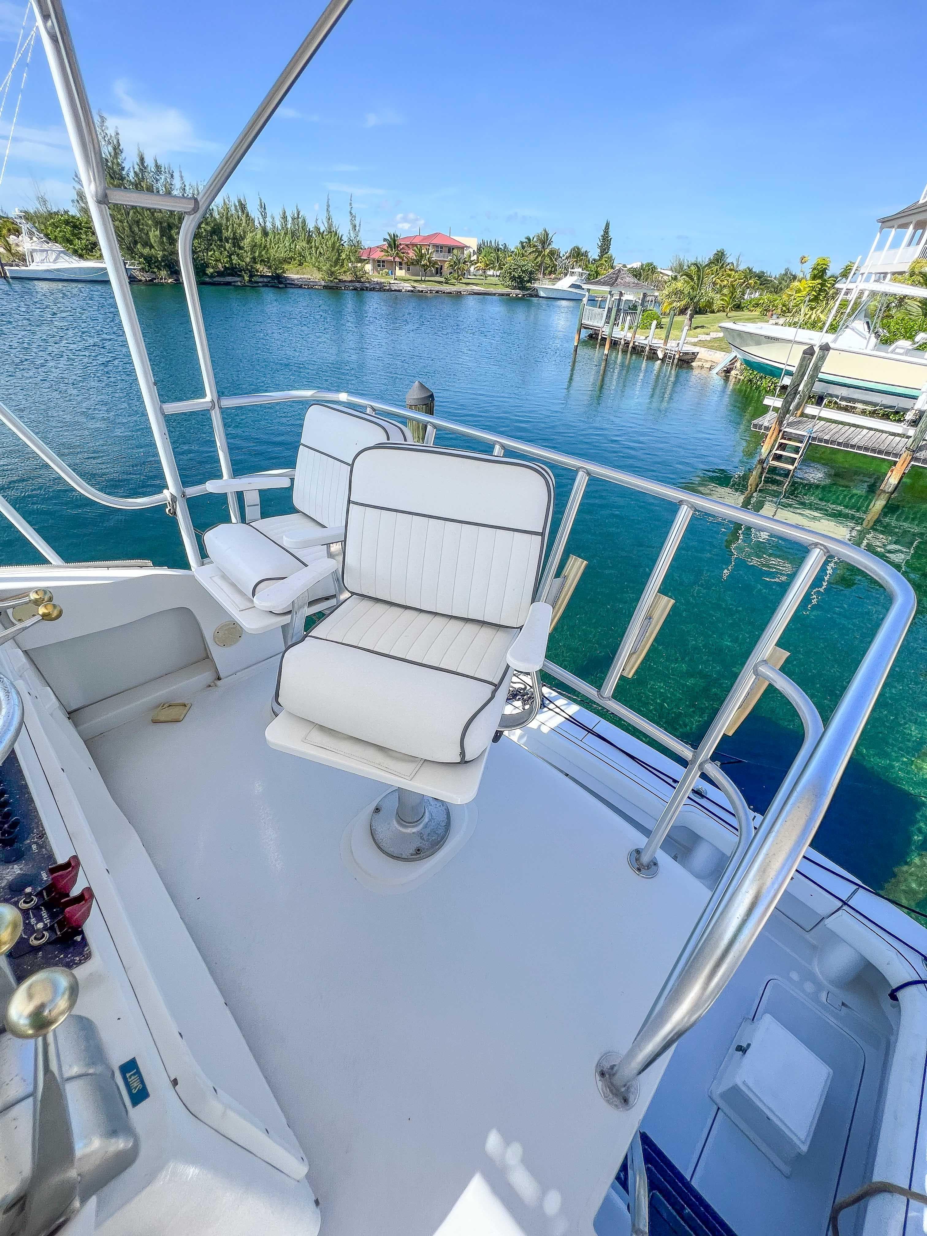 2000 Luhrs 400 Convertible boat with white seating on a sunny day.