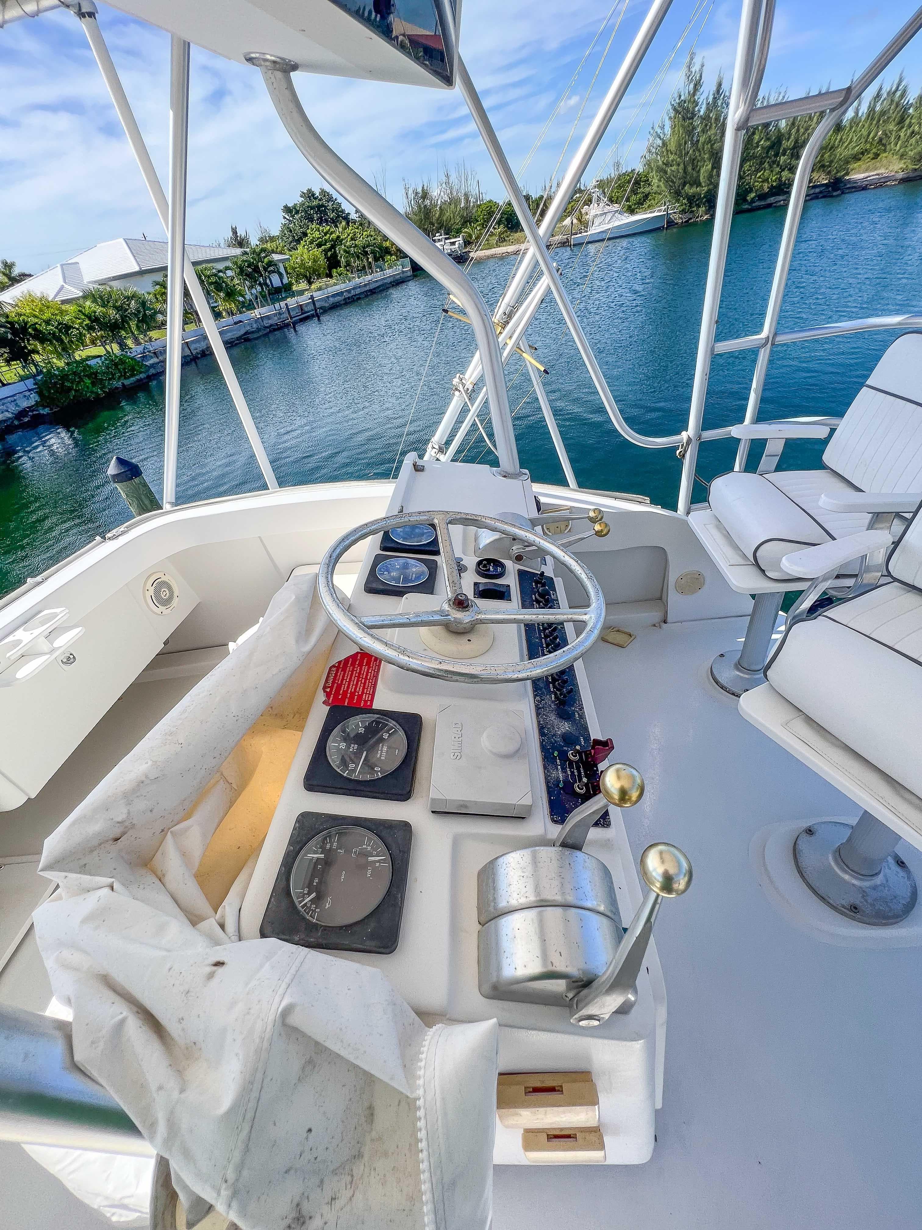 Helm of 2000 Luhrs 400 Convertible yacht with steering wheel and navigation instruments.