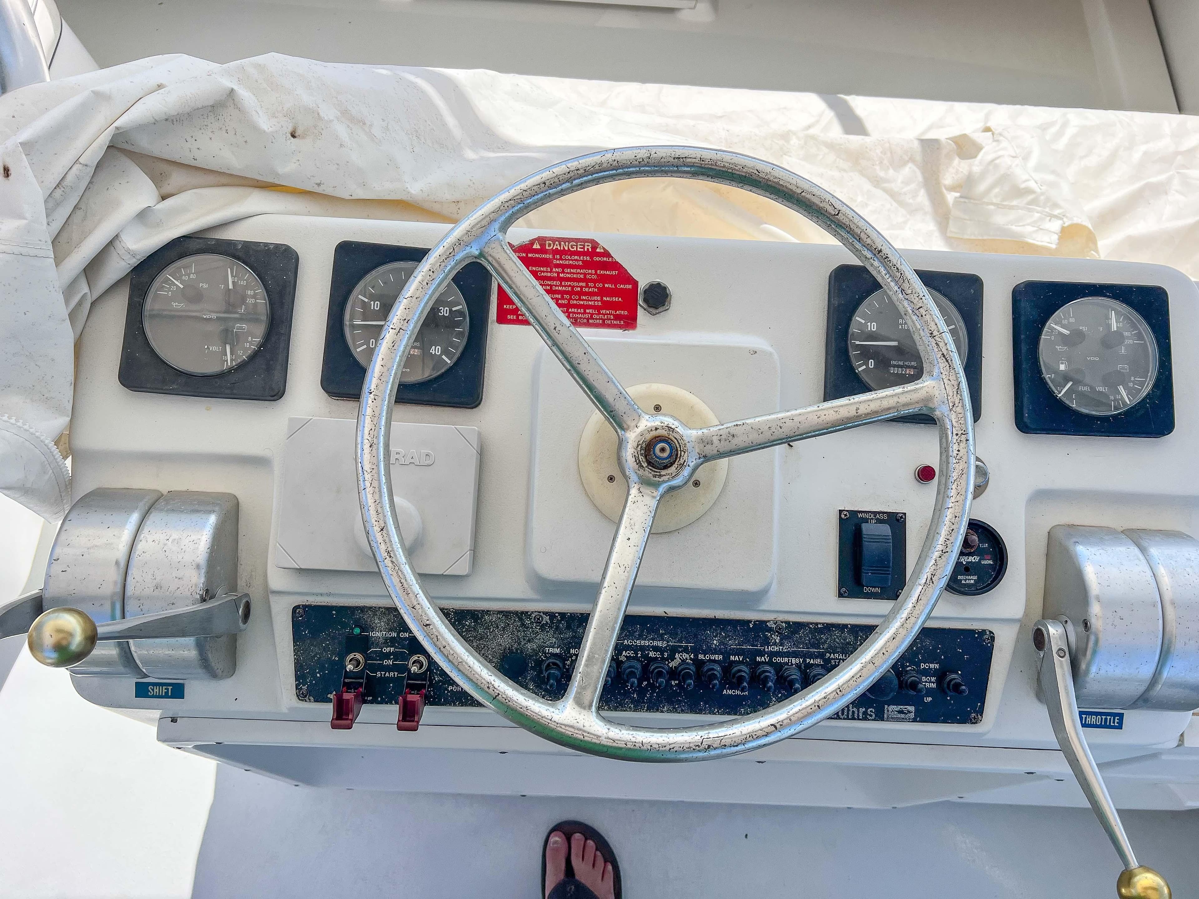 2000 Luhrs 400 Convertible boat helm with steering wheel and control panel.